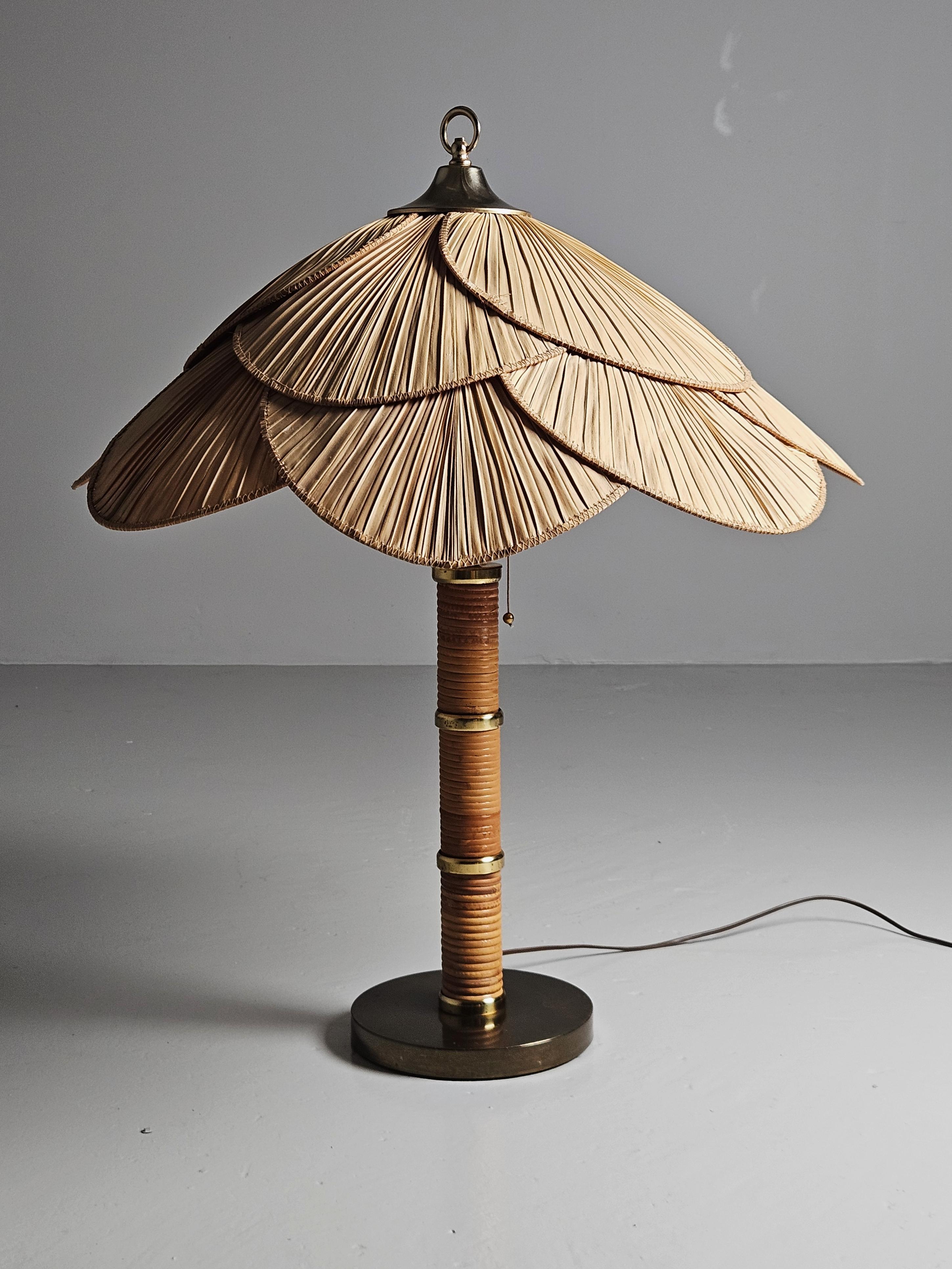 Very rare table lamp produced by Miranda AB in Svedala, Sweden. Designer is unknown.

Big sized, brass wrapped in rattan with a bamboo lamp shade.

In good condition, a few smaller tears/splits and scratches in leaves.