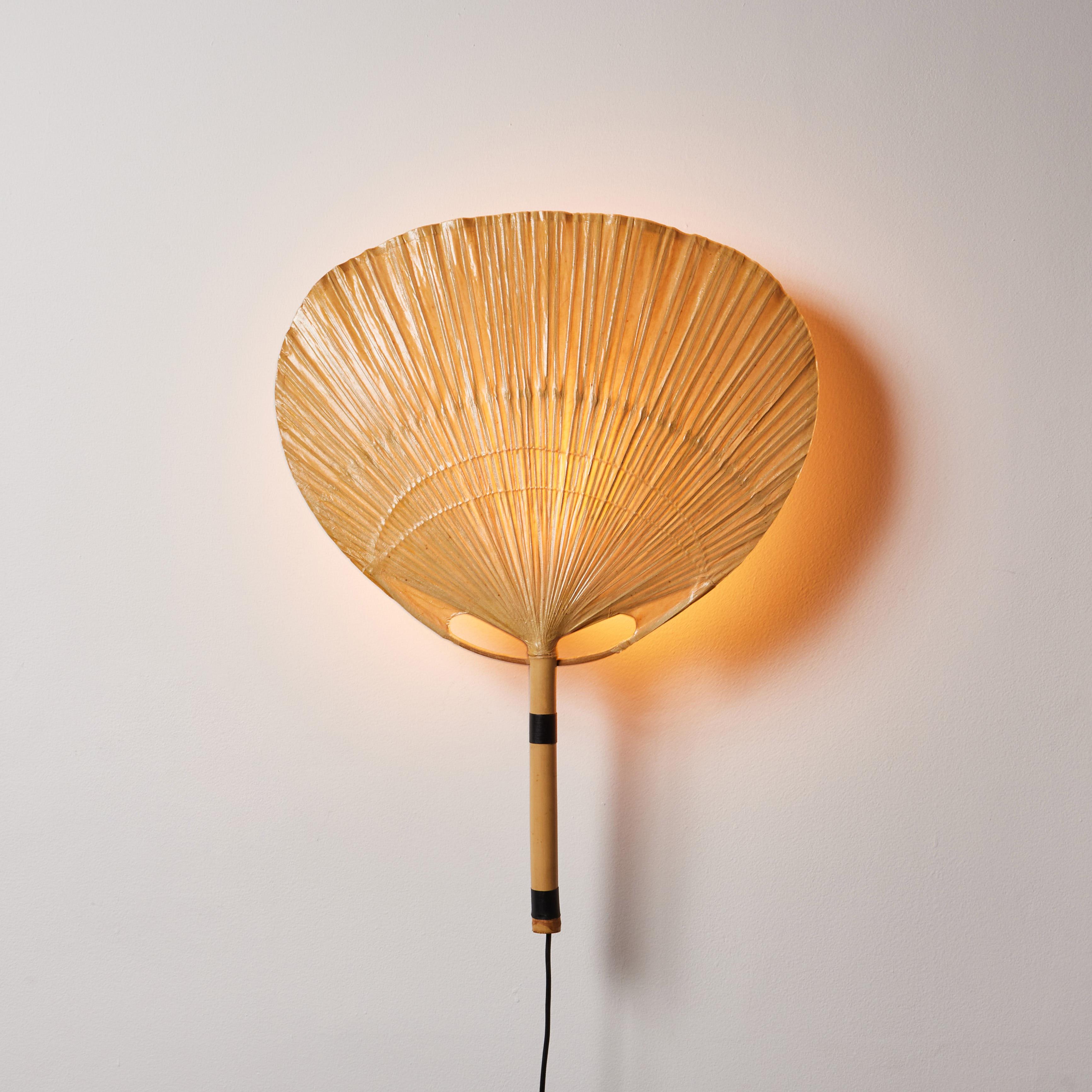 Uchiwa wall light by Ingo Maurer. Designed and manufactured in Germany, circa 1970s. Bamboo, rice paper. Original European cord. Each light takes one E27 40w maximum bulb. Bulbs provided as a one time courtesy.