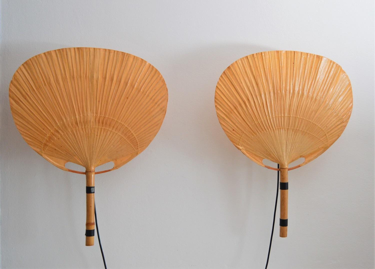 Two pieces of big vintage Uchiwa fan lamps with metal holder for wall hanging.
Designed from Ingo Maurer, Germany in 1973.
All fans are made of bamboo and rice paper.
The metal holders are equipped with original Edison bulb holders.
The lamps