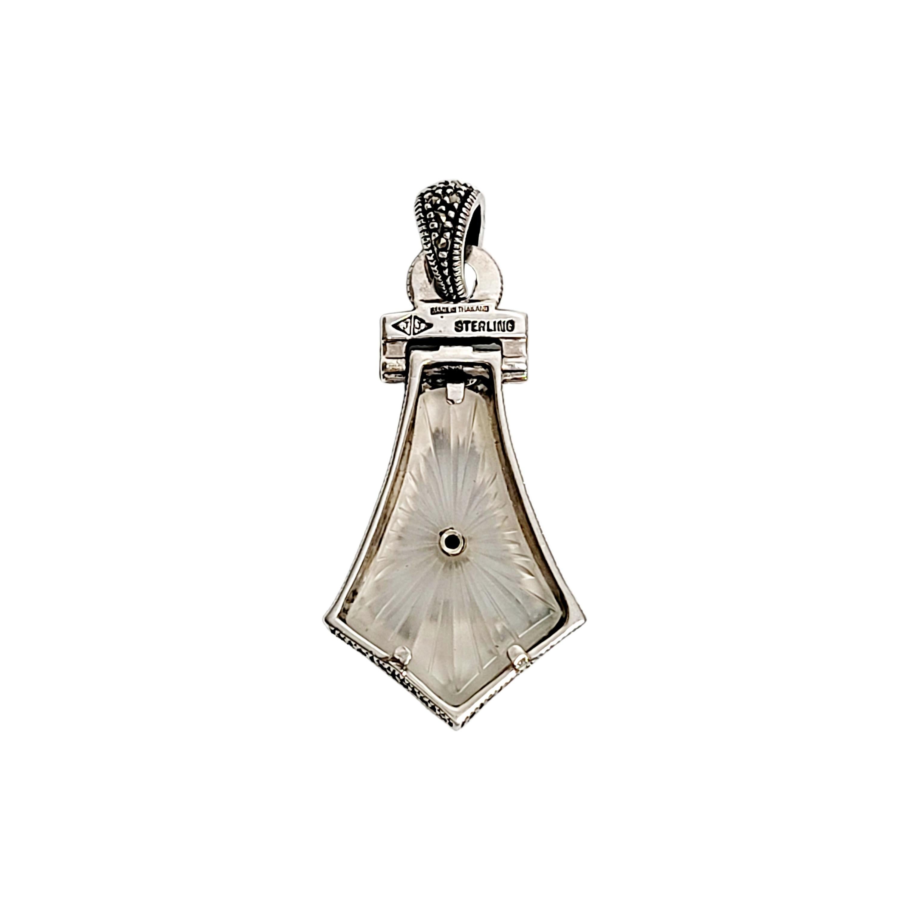 Sterling silver, marcasite and camphor glass pendant by Judith Jack.

Beautiful art deco design features camphor glass framed in marcasite encrusted sterling silver. Features leaf and floral designs.

Measures 2