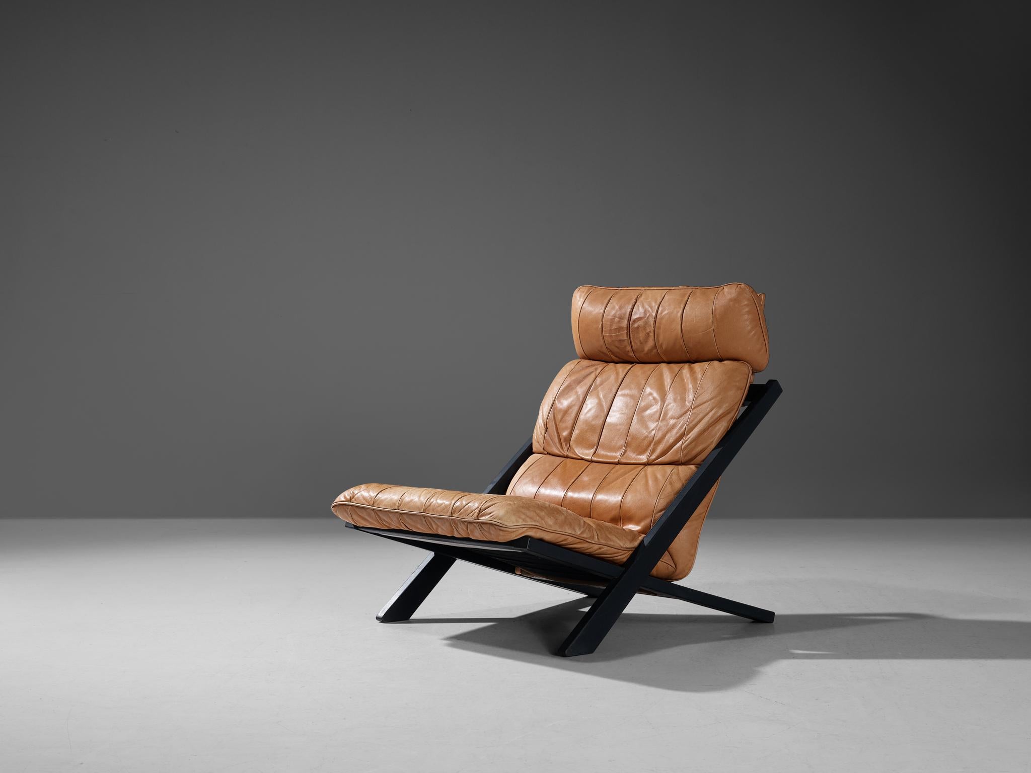 Ueli Berger for De Sede, lounge chair, wood and leather, Switzerland, 1970s

High back lounge chair designed by Ueli Berger and manufactured by Swiss quality manufacturer De Sede. The X-shaped frame consists of dark lacquered wood. This makes an