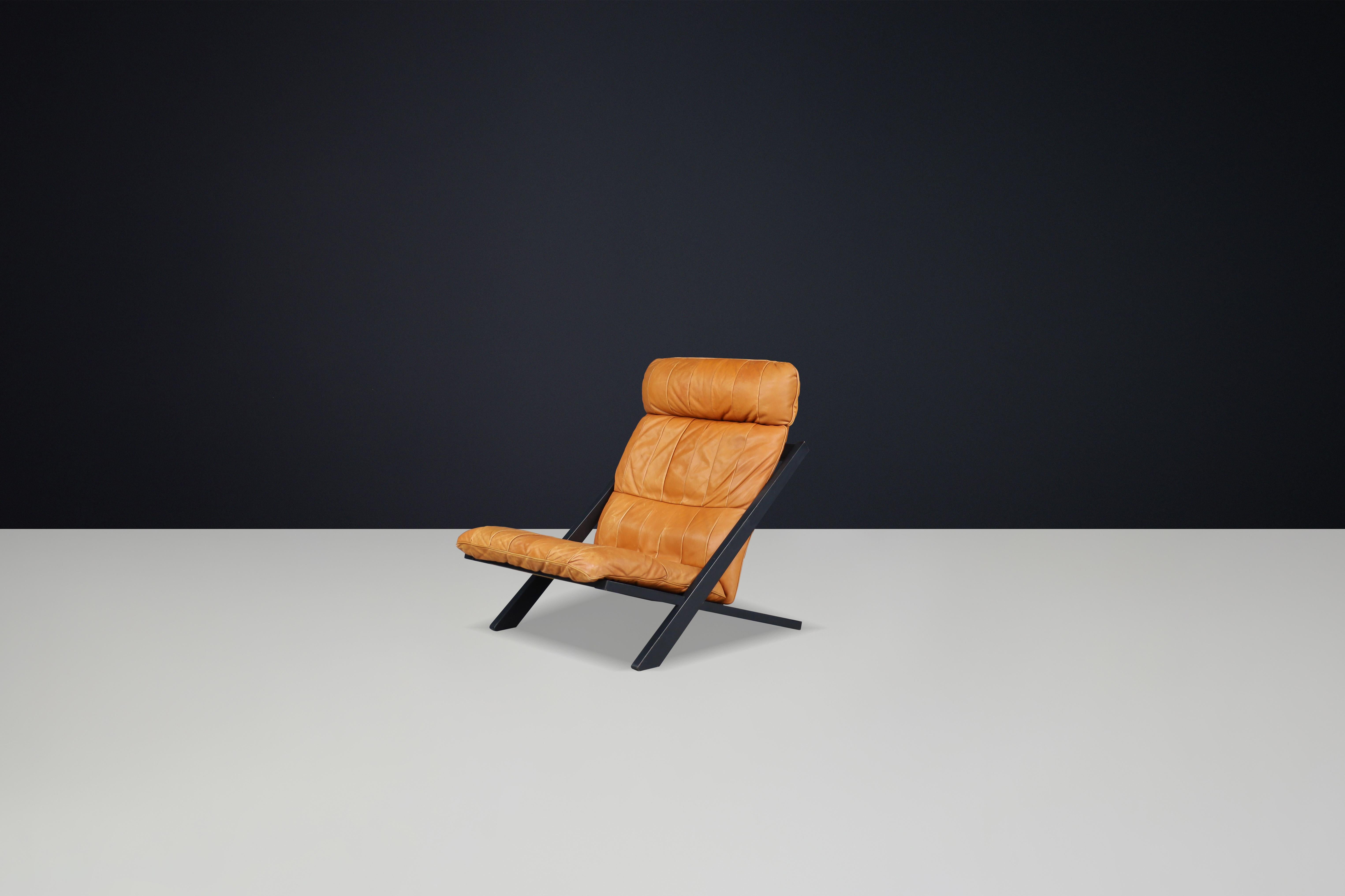 Leather Ueli Berger for De Sede, lounge chair, wood, Cognac leather, Switzerland, 1970s. For Sale