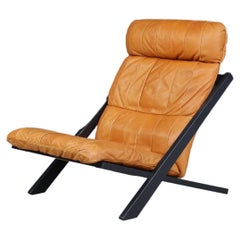 Ueli Berger for De Sede, lounge chair, wood, Cognac leather, Switzerland, 1970s.