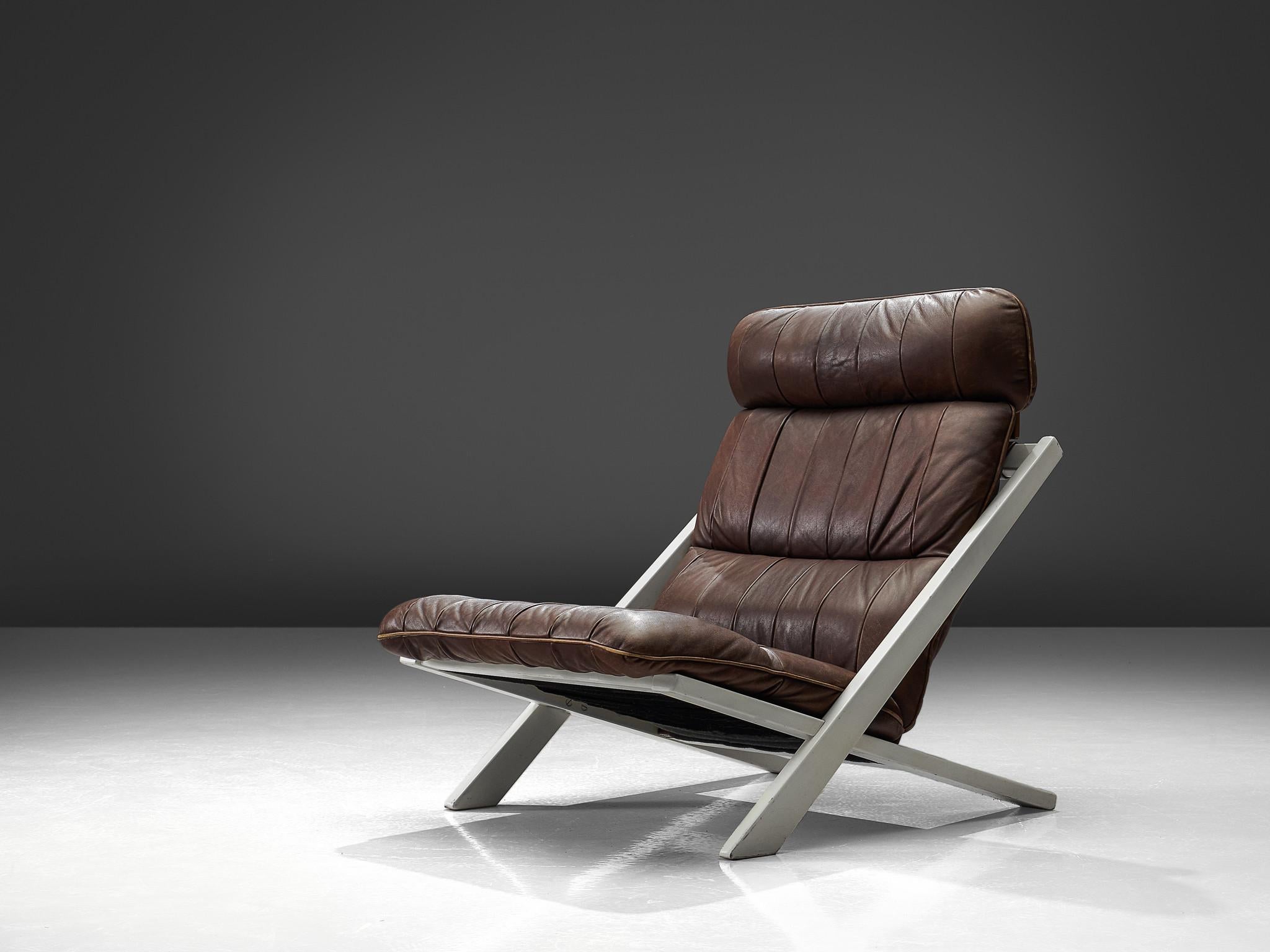 Ueli bergère for De Sede, lounge chair, Switzerland, 1970s.

High back lounge chair by de Swiss quality manufacturer De Sede. The X-shaped frame consists of black lacquered wood. This makes an interesting contrast to the warm patinated cognac brown