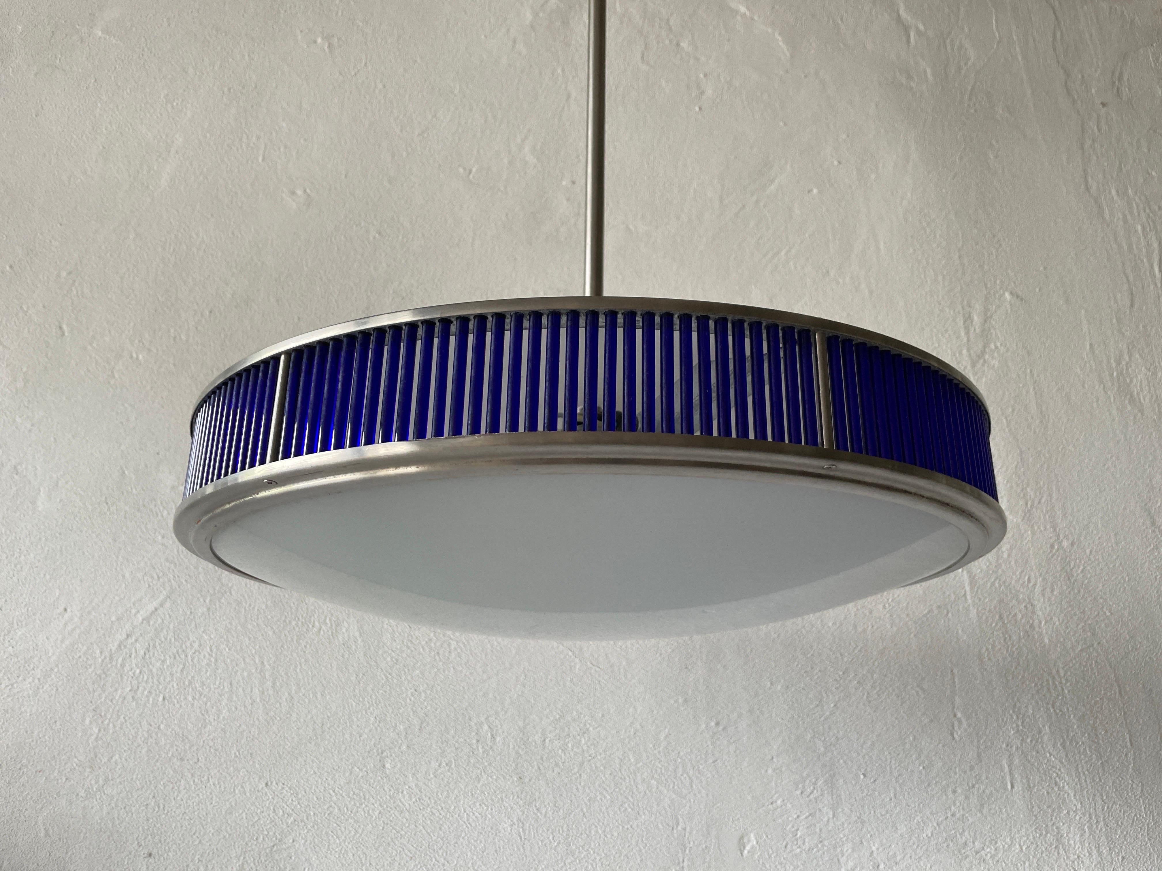 Ufo Design glass & blue plexiglass large ceiling lamp by Gunther Lambert, Germany, 1970s

Lampshade is in good condition and very clean. 
This lamp works with 3x E27 light bulb. 
Wired and suitable to use with 220V and 110V for all