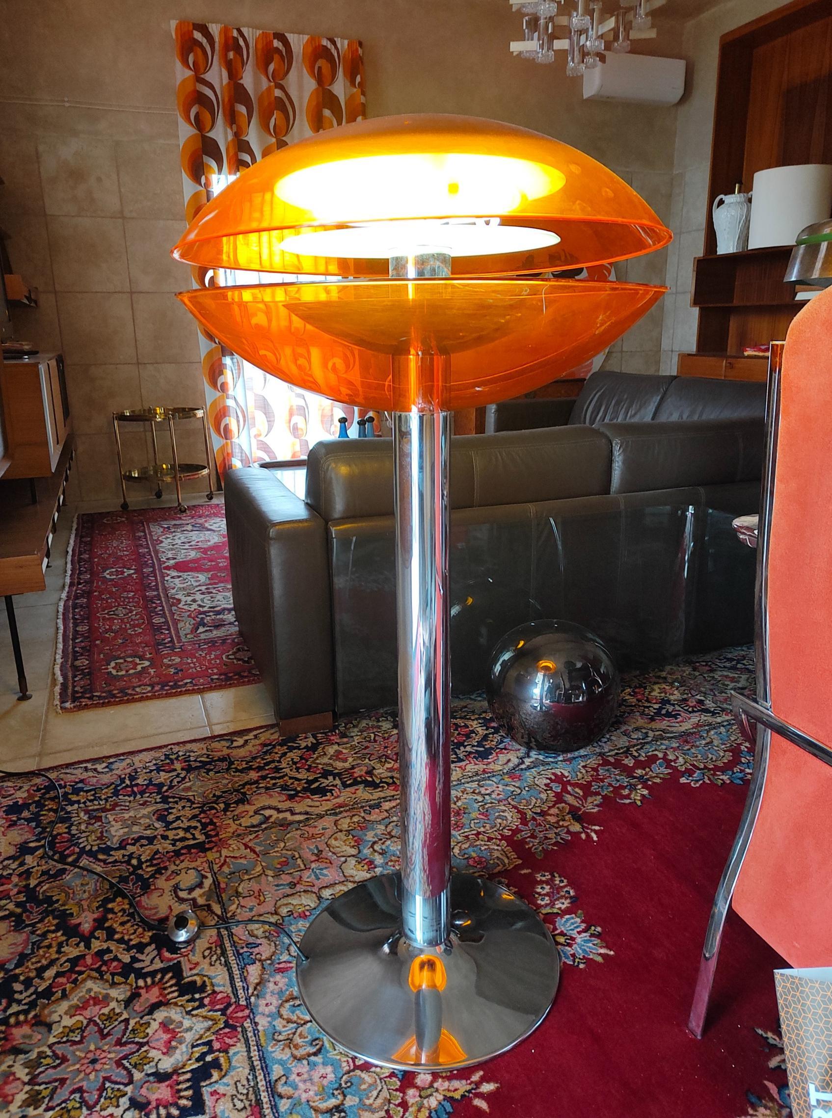 Rare and wonderful floor lamp in perfect Space Age style, original of the 70s, perfectly preserved because it was found in the warehouses of a store. 
Made of chromed steel with a large orange plexiglass hat.
It measures 140 centimeters in height,