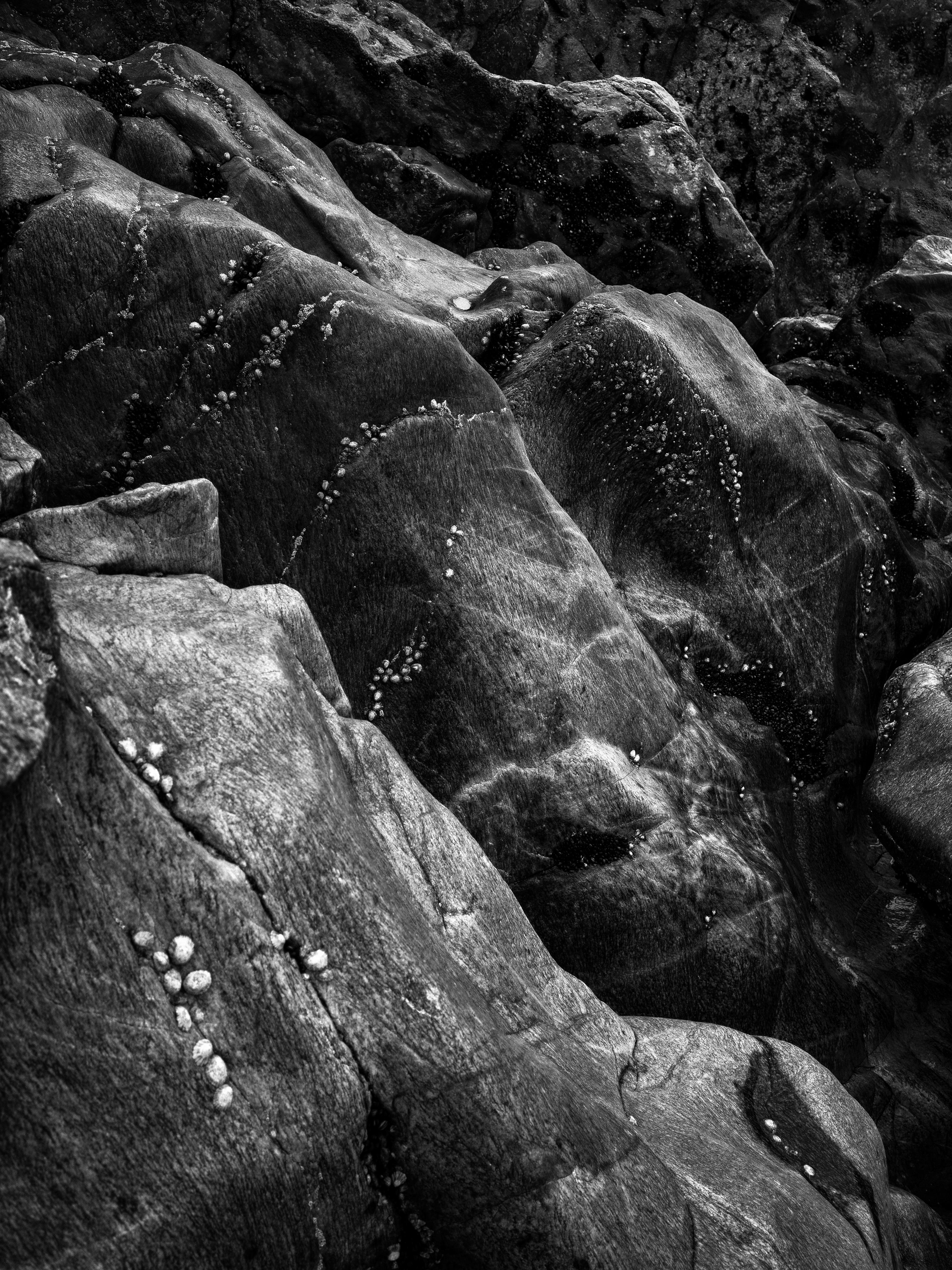 Ugne Pouwell Landscape Photograph - Gandarem II - black and white photograph of dark rock 