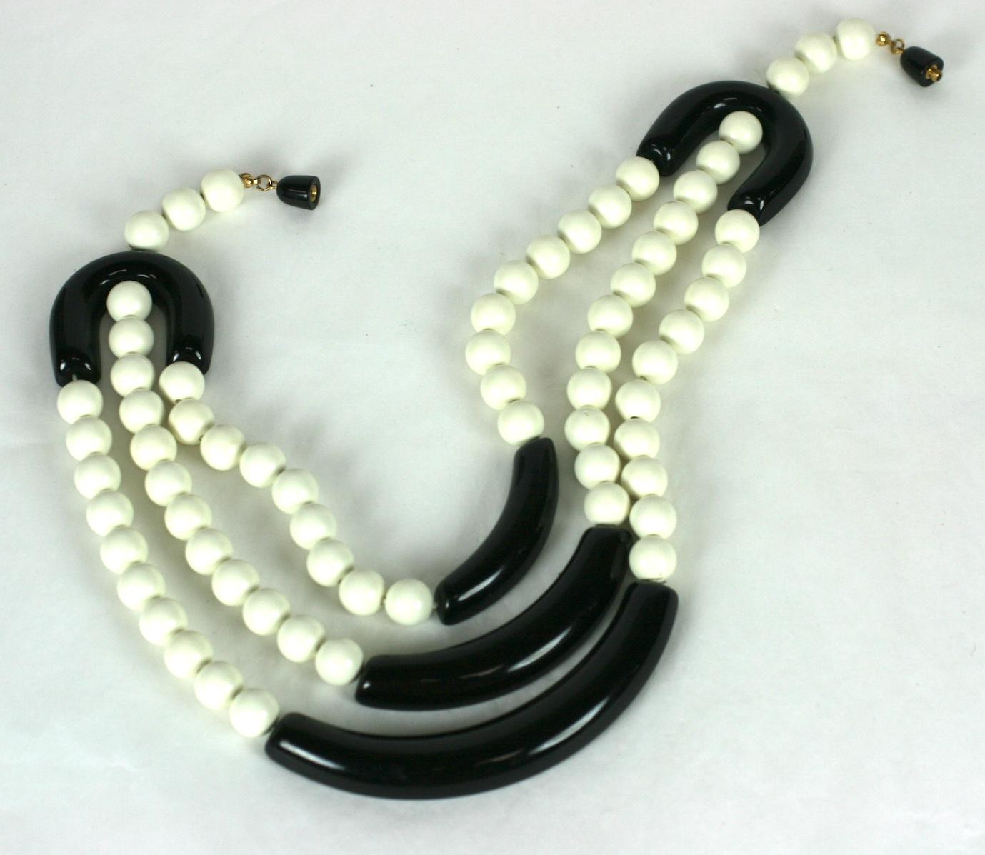 Ugo Correani  for Chloe, designer Karl Lagerfeld's Art Deco inspired bead necklace. Composed of   three strands of white resin beads punctuated by black resin arcs. Black resin barrel clasp.
Excellent Condition, Unsigned. 
L 18.50