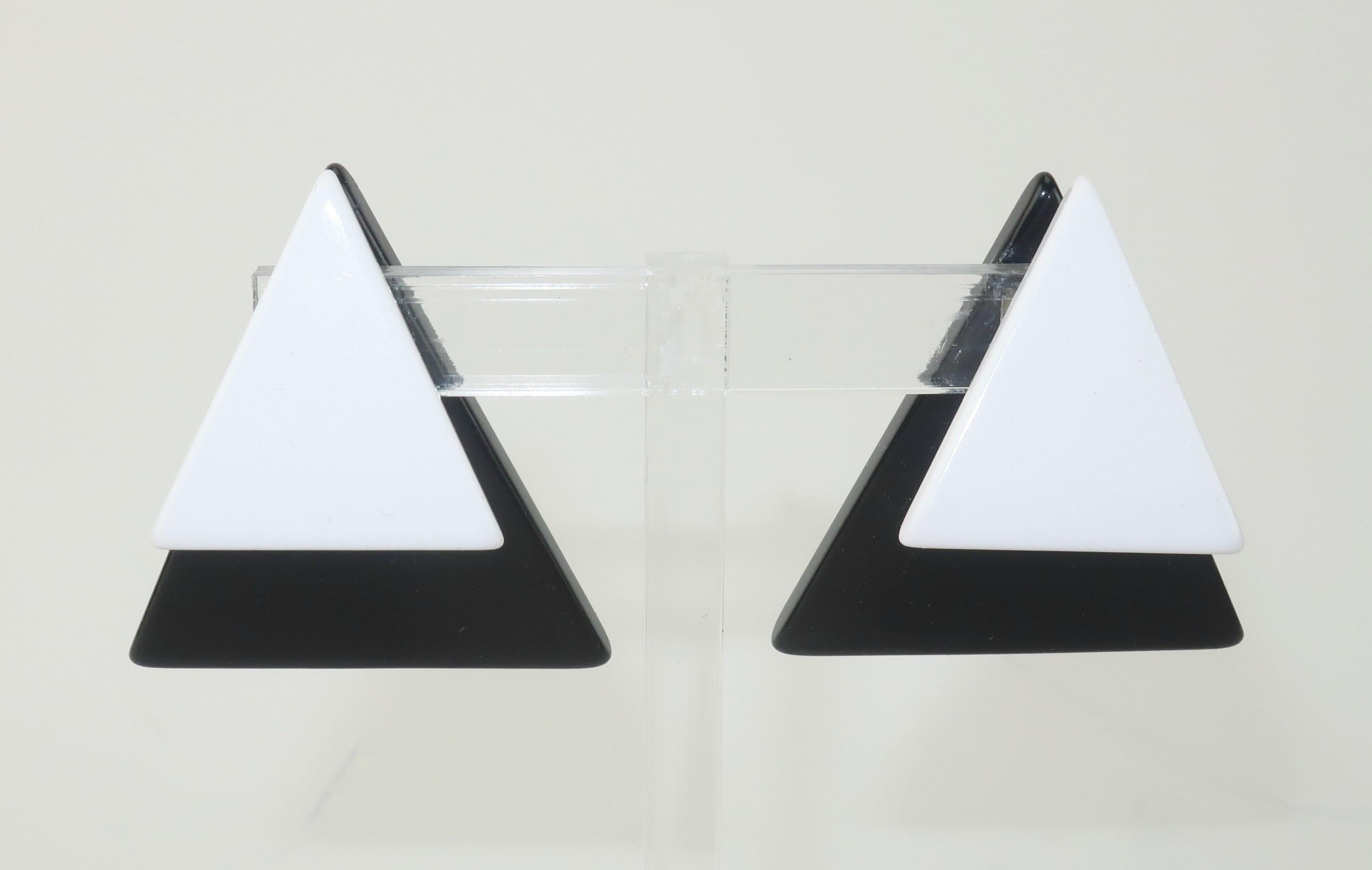 Die schwarz-weißen dreieckigen Ohrringe aus Harz des italienischen Schmuckdesigners Ugo Correani haben eine einzigartige Clip-Feder, die es ermöglicht, ein Dreieck vor dem Ohr und das andere hinter dem Ohr aufzuhängen.  Überraschenderweise ist die