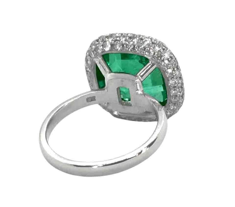 This exquisite emerald and diamond  ring features a bright green octagonal shaped emerald at the center, surrounded by a glittering halo of diamonds.
Crafted in 18k white and yellow gold

The center stone is a 5.73ct octagonal emerald with very well