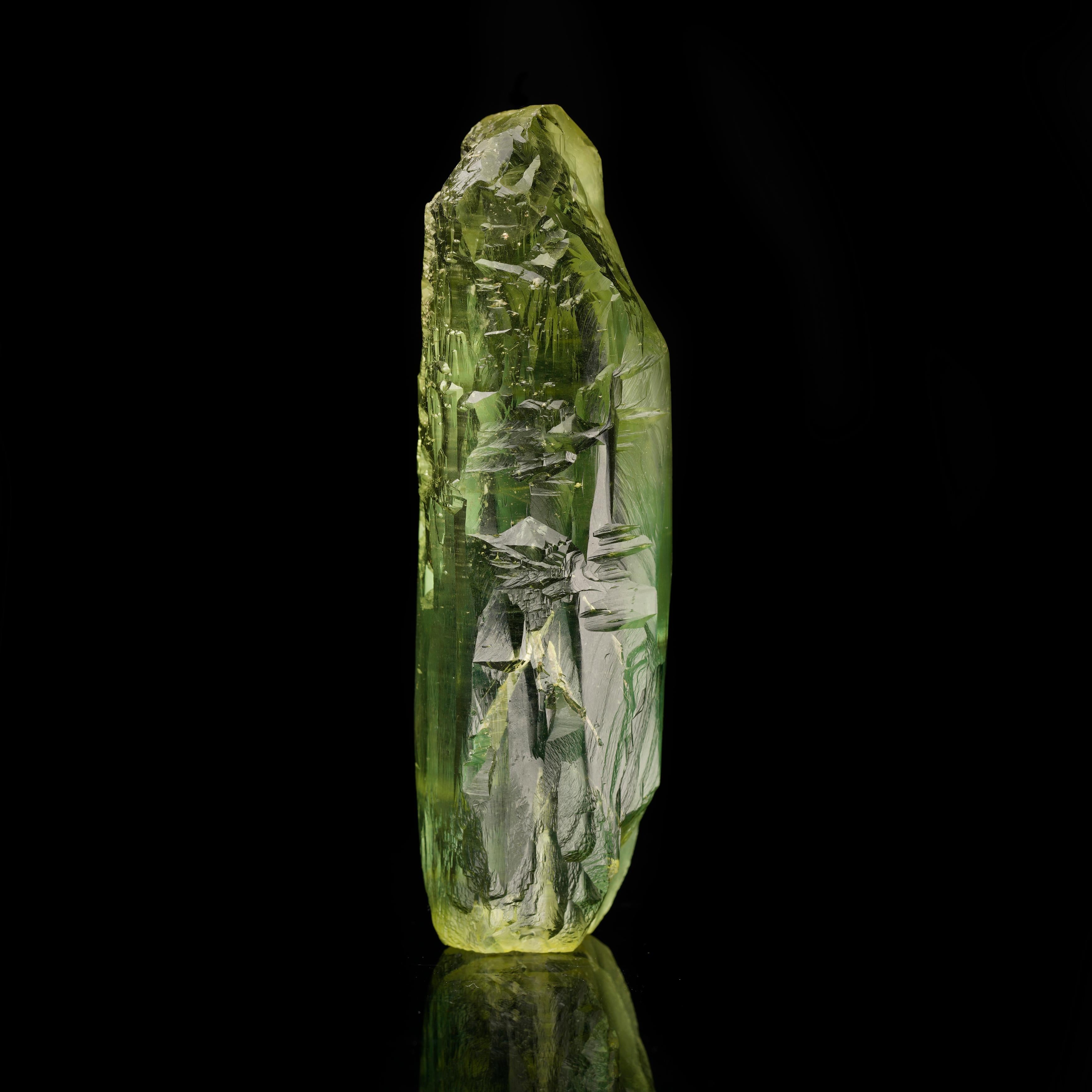 This stunning, gemmy finger of heliodor from the Ukraine features a lovely yellowish-green hue with incredible clarity and a rough-hewn appearance due to the gem mineral's characteristic  natural etching. A substantial find for the discerning