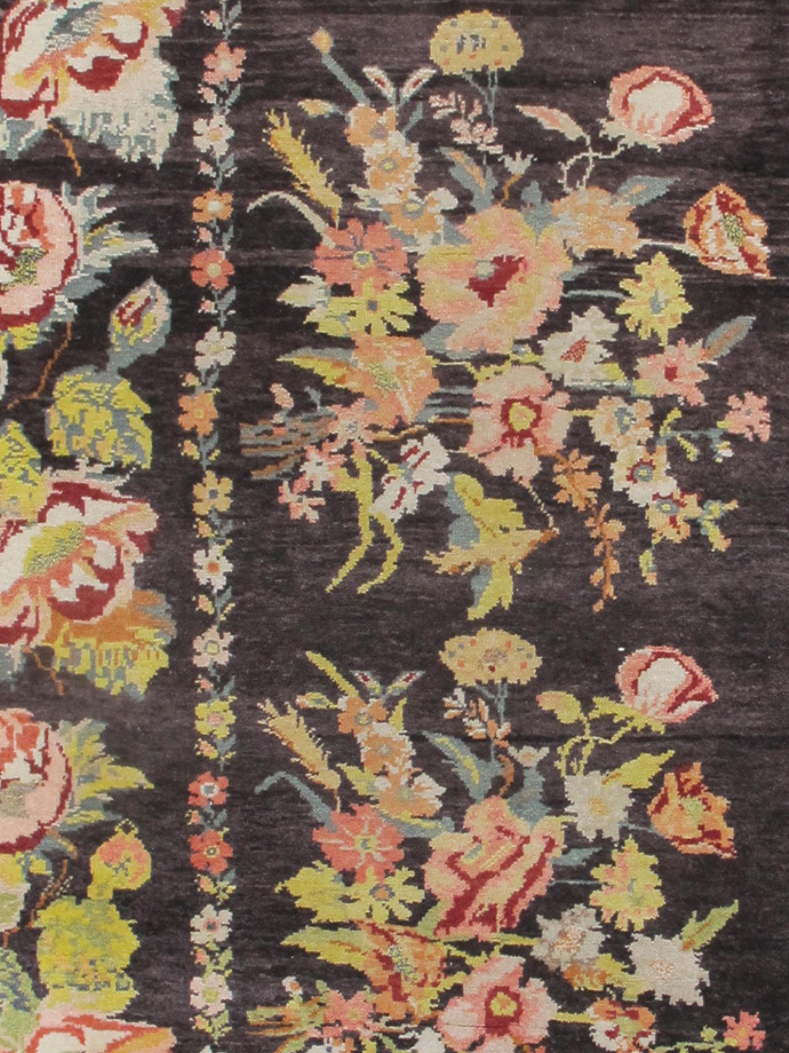 Ukrainian Rug, c. 1900

This knotted pile carpet draws large bunches of floral bouquets against a dark ground. Complementary floral borders link large rose flowers and foliage. While the inspiration for this imagery was French, this carpet was most