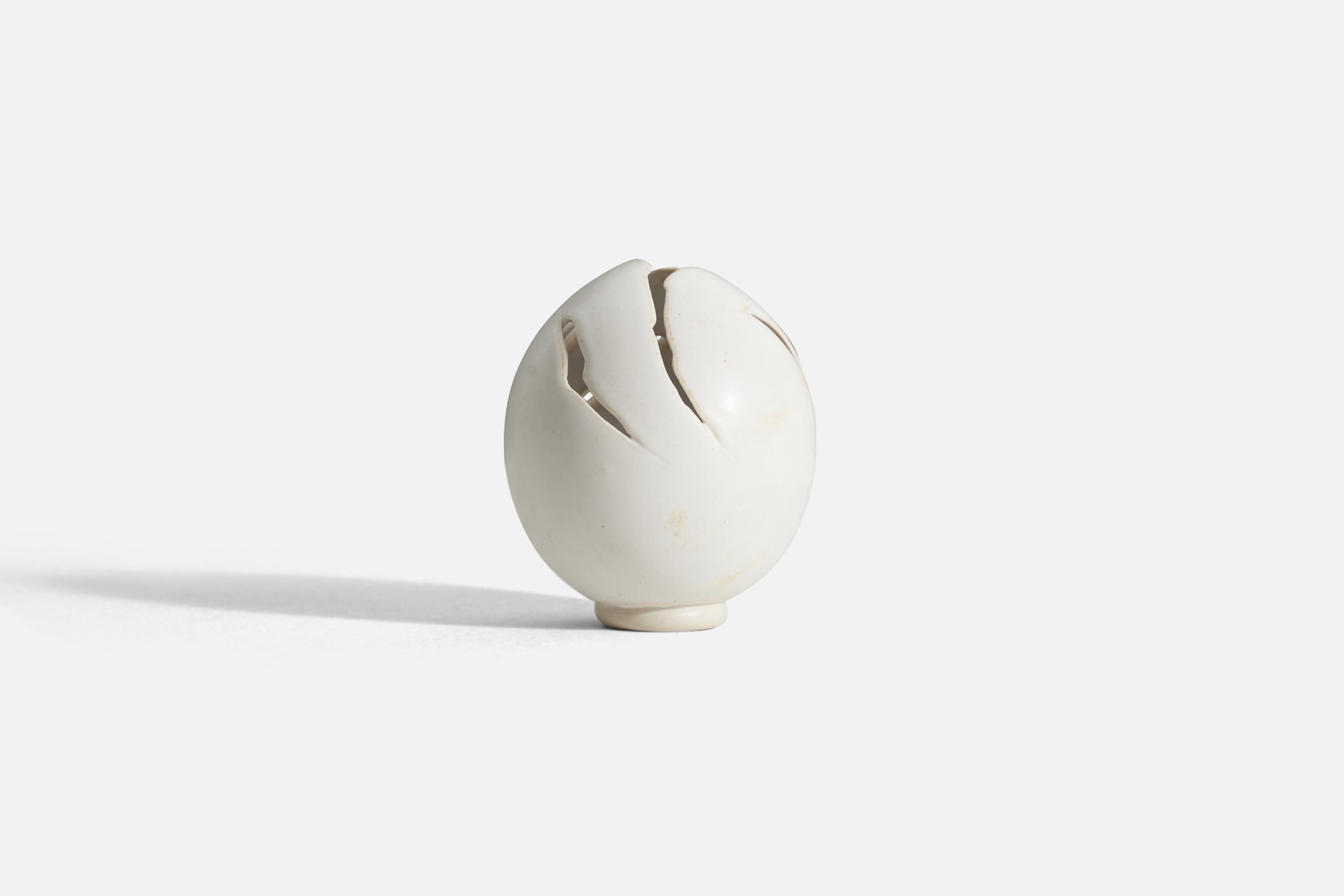 A small white-glazed ceramic sculpture. Produced by Ulf Nordfjell in 1987, signed and dated to underside.