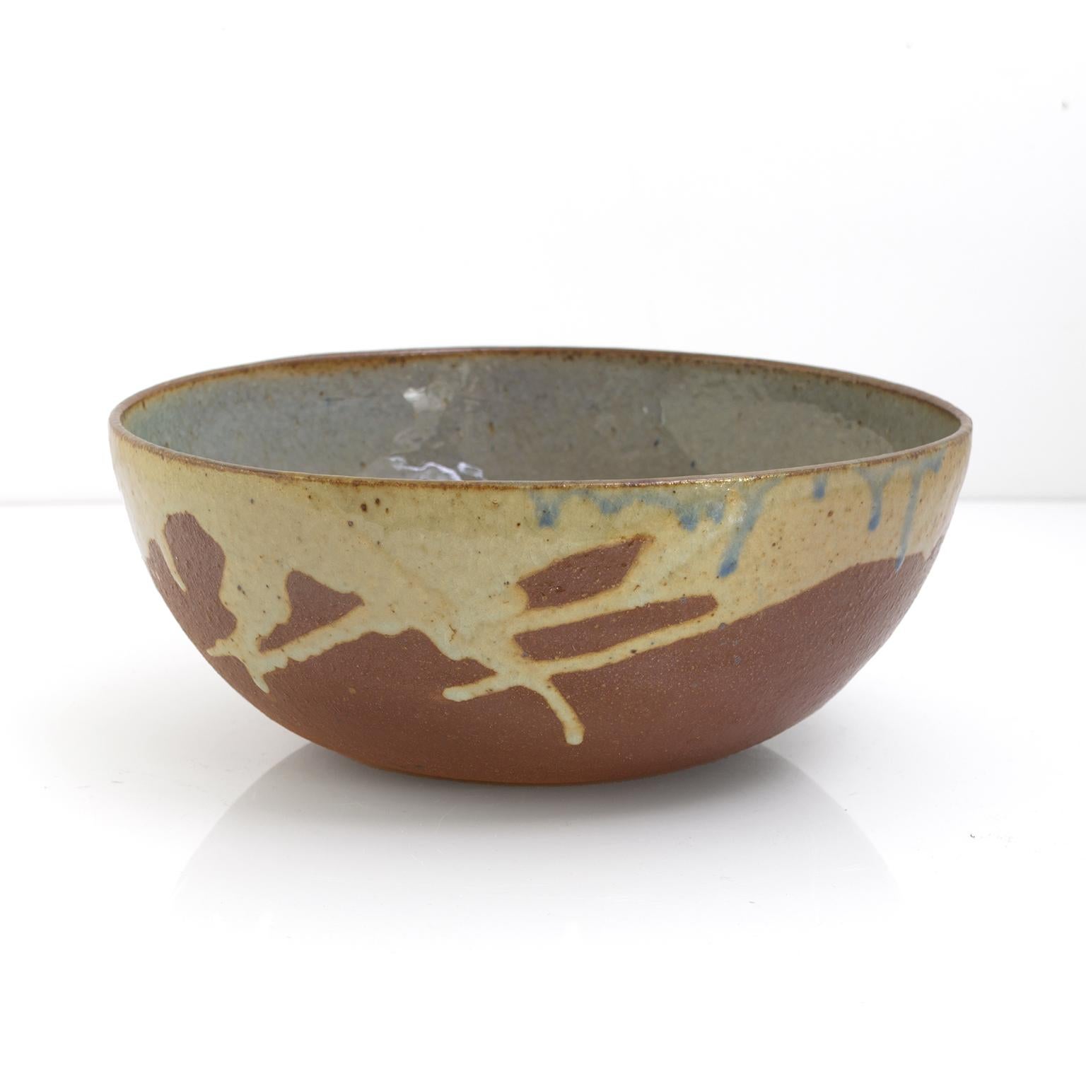 Made by Hungarian born Gustav and his Swedish wife Ulla, hand thrown and glazed ceramic bowl, dated 1976. These artists are know for their sublime forms and expressive glaze techniques. 

Measures: Diameter: 10.5“ Height: 4.5“.