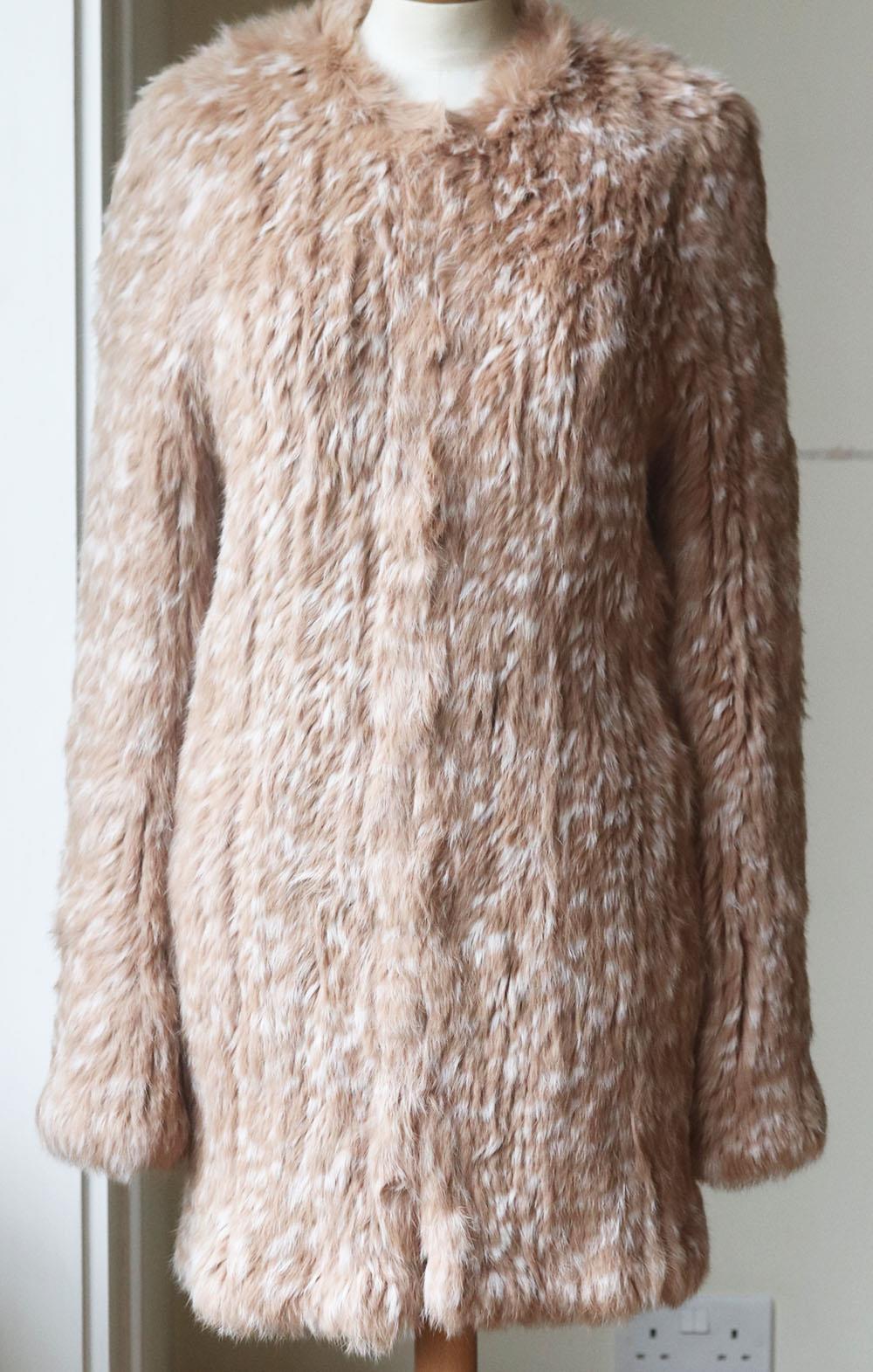 Ulla Johnson's 'Christa' animal-print knitted rabbit-fur coat made its debut for winter months, it's cut for a loose fit, which means you can layer it over knitwear without feeling restricted. Beige, white and brown rabbit-fur. Hook fastening at