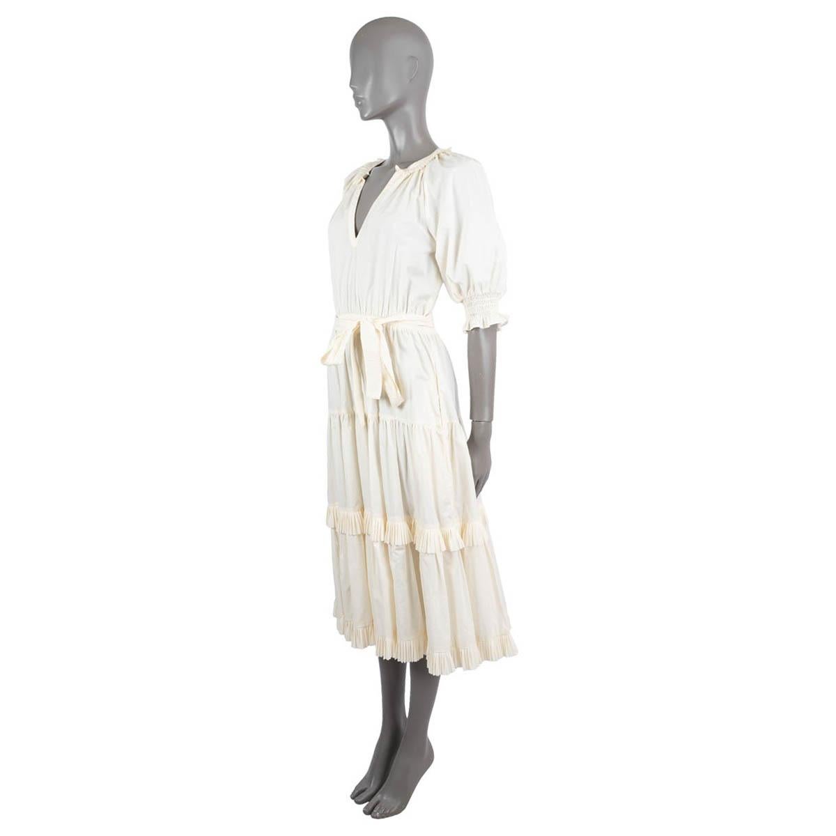 100% authentic Ulla Johnson Dasha tiered midi dress in ivory cotton poplin (100%). Features a V-neck with ruffled collar, shirred short puff sleeves, an elastic waist with self-tie belt, slit side pockets and fluttery skirt thats tiered and ruffled.