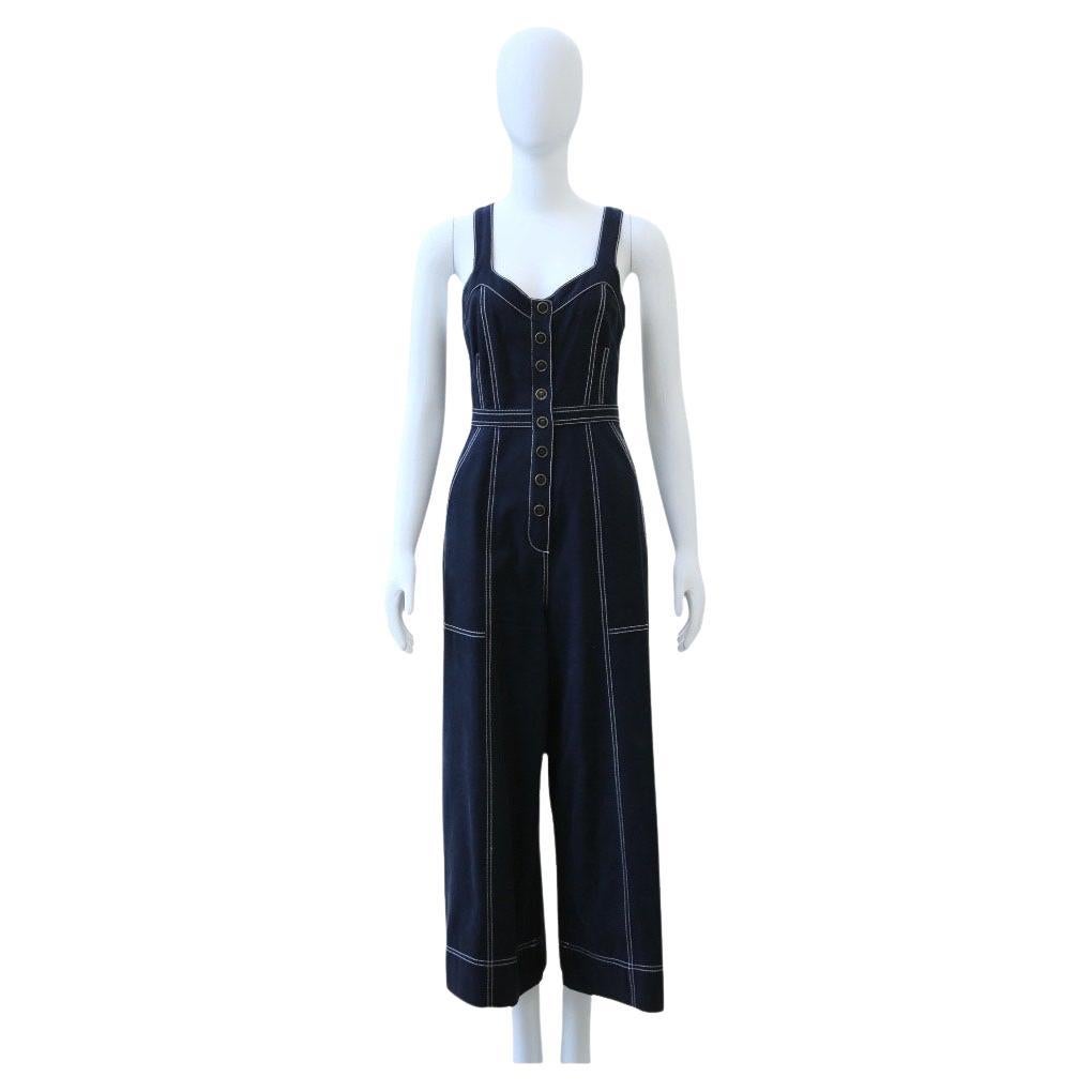 Ulla Johnson Sleeveless Wide-Leg Denim Jumpsuit

This effortlessly cool denim jumpsuit from Ulla Johnson features a flattering V-neckline, contrast topstitching, and a structured silhouette that cinches at the waist. The button-front detail and