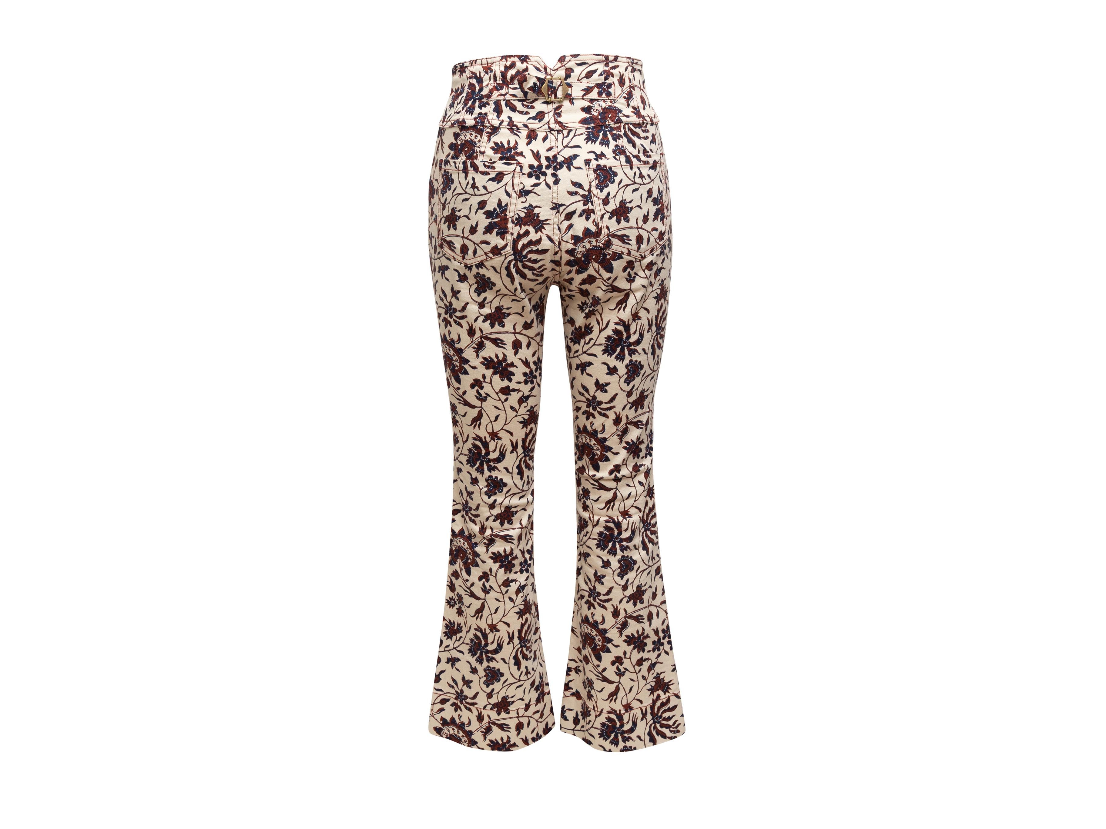 Product details: White, maroon, and navy high-rise flared pants by Ulla Johnson. Botanical print throughout. Four pockets. Button closures at front. 27