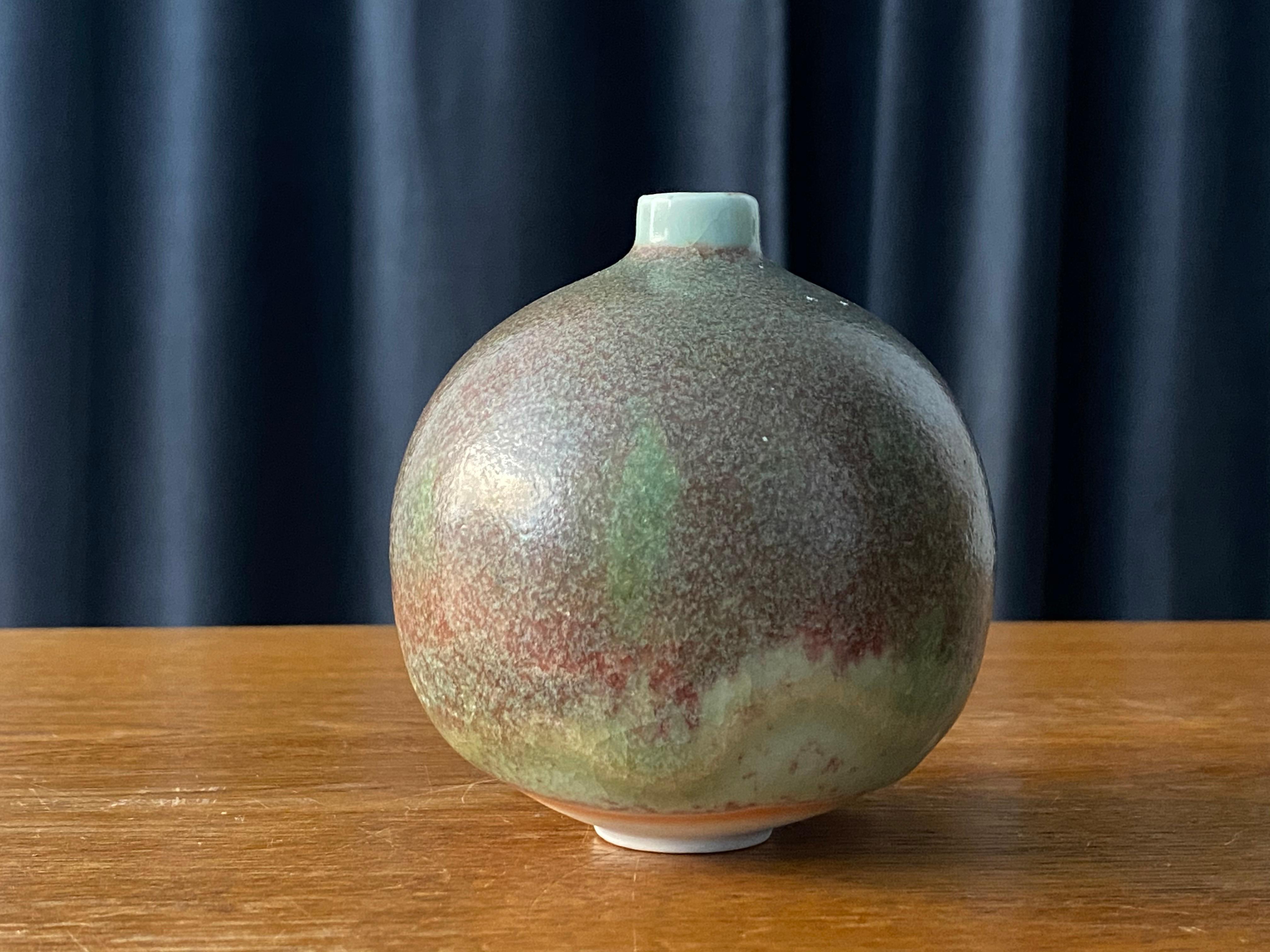 A small and unique studio vase by Ulla och Gustav Kraitz, artist studio Fogdarp, Förslövsholm, Sweden, signed and dated 1976. Has a highly artistic and complicated glaze with tones of turquoise / blue, grey, orange and red.

Other ceramicists of