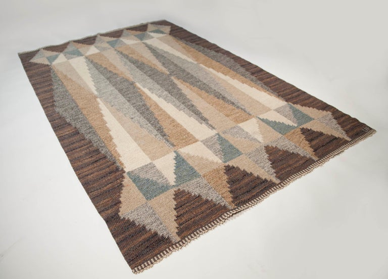 Ulla Parkdah Swedish flat-weave rug, signed UP, Sweden, 1960s

This is an excellent example of Ulla Parkdal as a master weaver of exquisite Swedish rug designs. With a distinctly midcentury geometric design, the Grey and tan tones intersect in