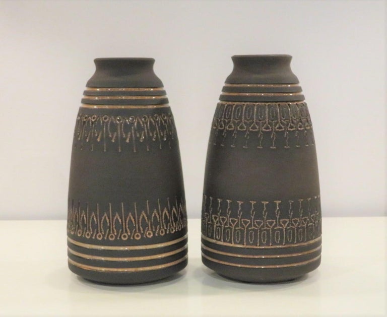 This grouping of 5 stoneware pieces by Ulla Winblad was produced from the late 50s (weed pot) through the early 1960s. These are all handmade unique pieces with sgraffito design. Three pieces are without a glaze, emphasizing the rustic feel of the
