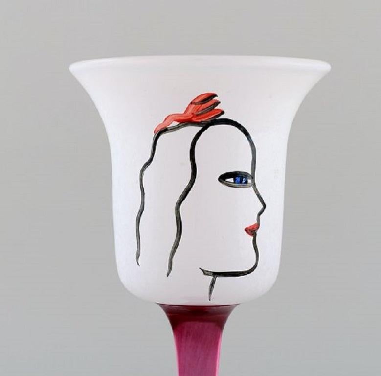 Ulrica Hydman Vallien for Kosta Boda. Hand painted wine glass in mouth-blown art glass decorated with woman's face, 1980s.
Measures: 24 x 10 cm.
In very good condition.
Signed.