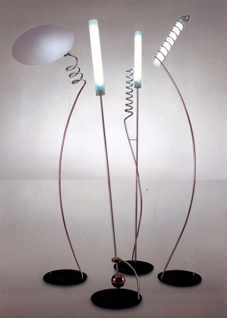 A floor lamp designed by Ulrich Hoereth as a part of a family of lamps called: Solanaceae for the Woka Lamps Art collection, with an iron base, a swiveling and lacquered shade from iron-sheet, connected with a sculptural formed tube from stainless