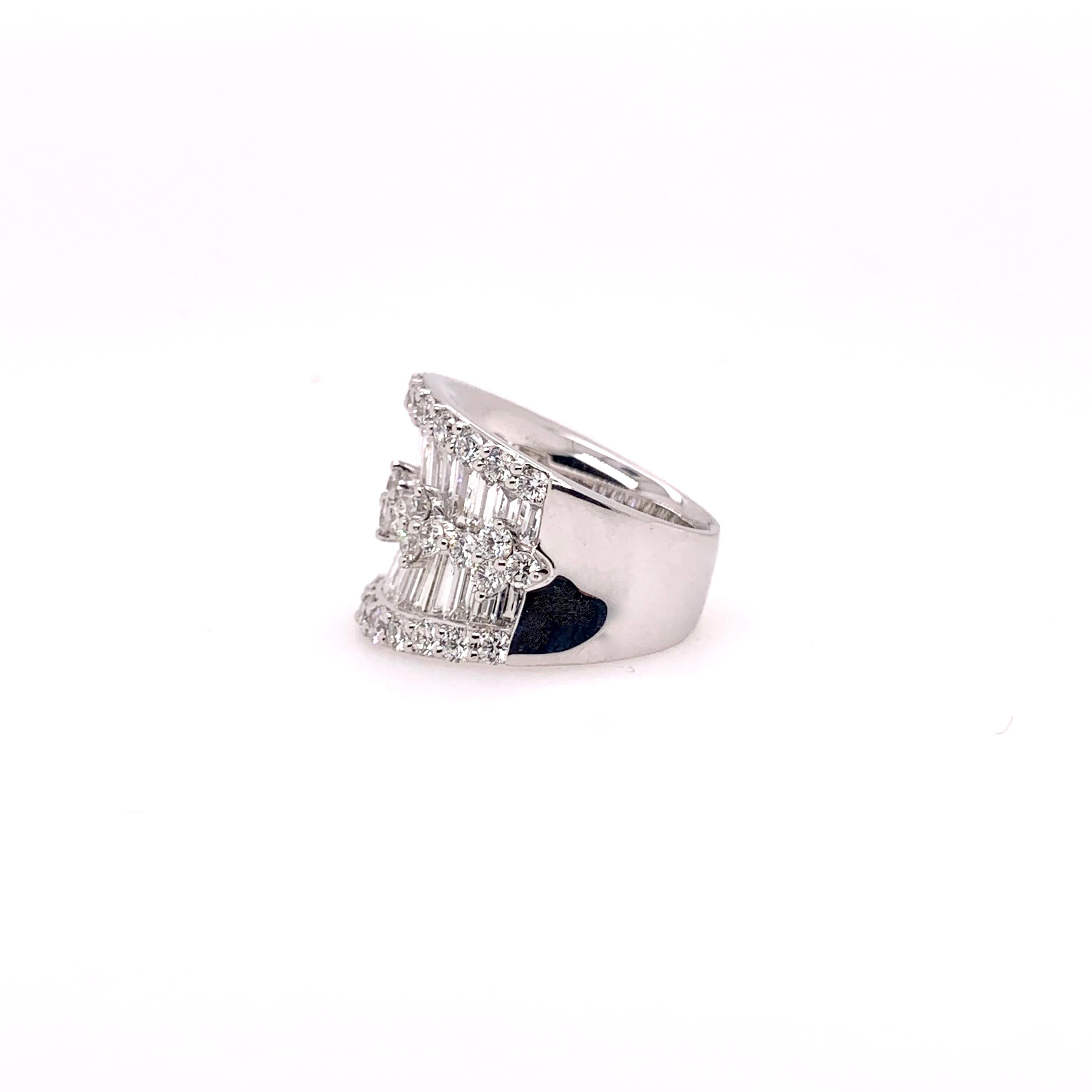 One of our signature designs, this platinum diamond band has 4.92 cts. of round brilliant cut diamonds and diamond baguettes.   It is meticulously made with the finest workmanship.  The platinum adds a solid, substantial weight to make it feel like