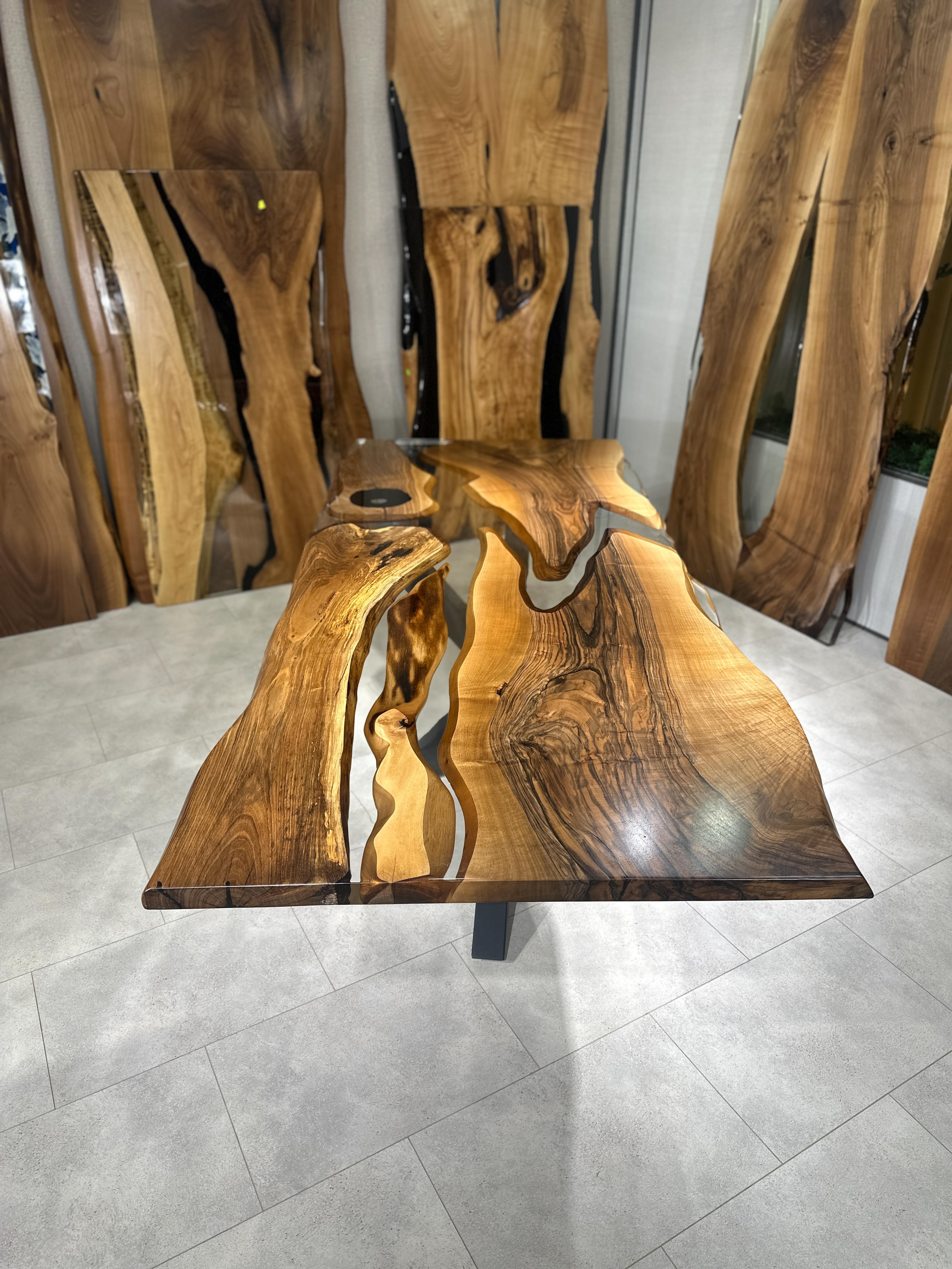 Walnut Live Edge Custom Clear Epoxy Resin Dining Table 

This table is made of 500 years old walnut wood. The grains and texture of the wood describe what a natural walnut woods looks like.
It can be used as a dining table or as a conference table.