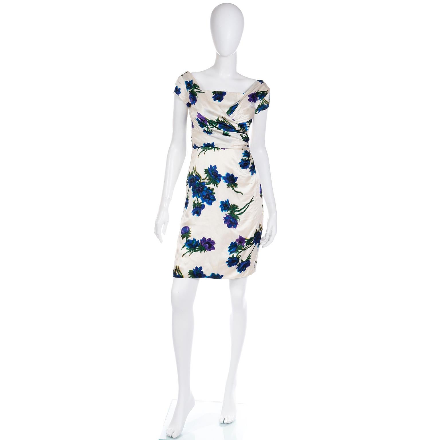 This exceptional vintage mid century dress is made from some of the finest silk we've come across! When I tell you that it feels like butter, I mean, literally that soft of a silk! The fabric is white with bold blue, purple and green floral print.