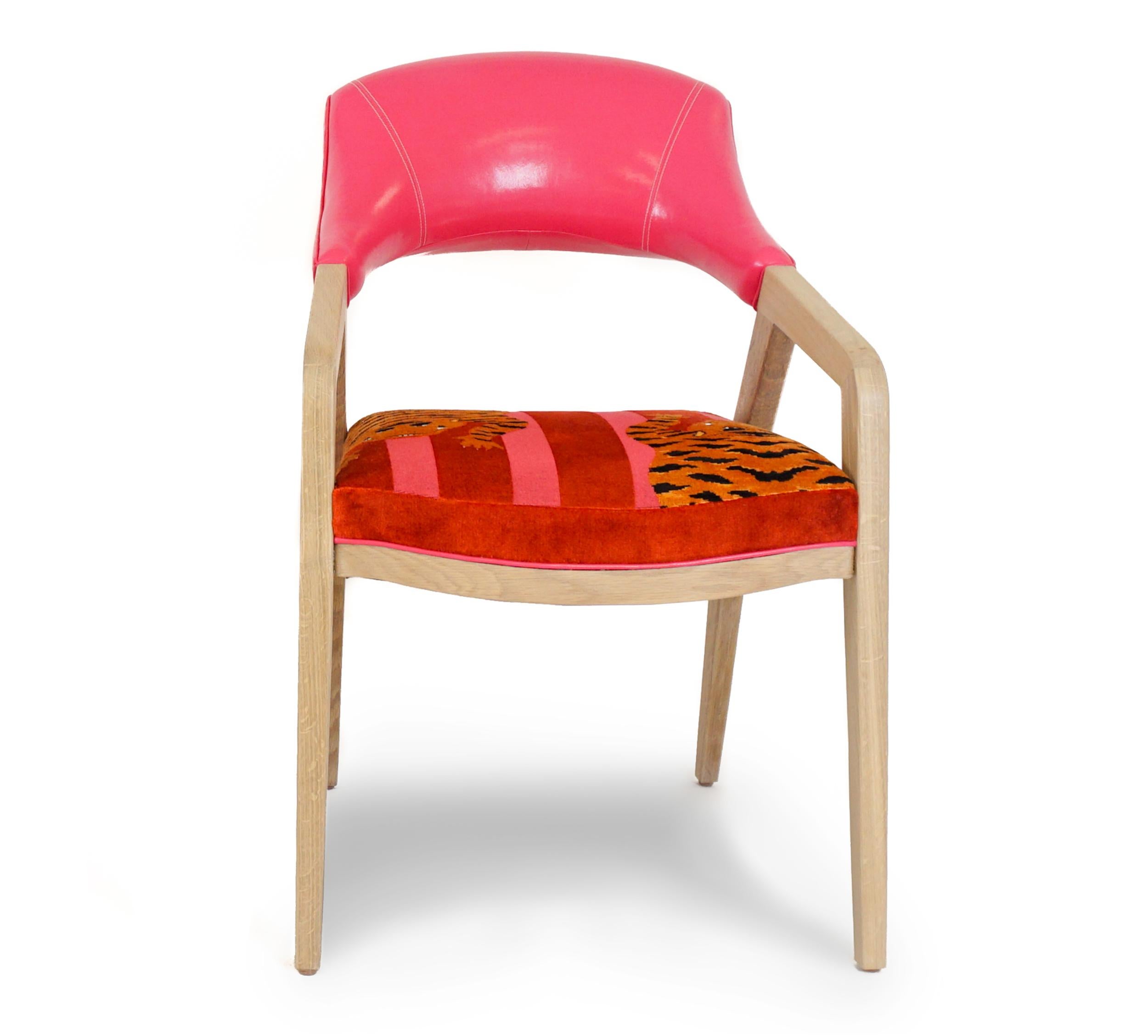 About this piece
Ultra modern frame with striking lines. Solid hard maple frame and carved details. As shown with bubble gum faux patent leather back and iconic Schumacher tiger velvet seat.

How we work
Made to order by Connecticut-based furniture