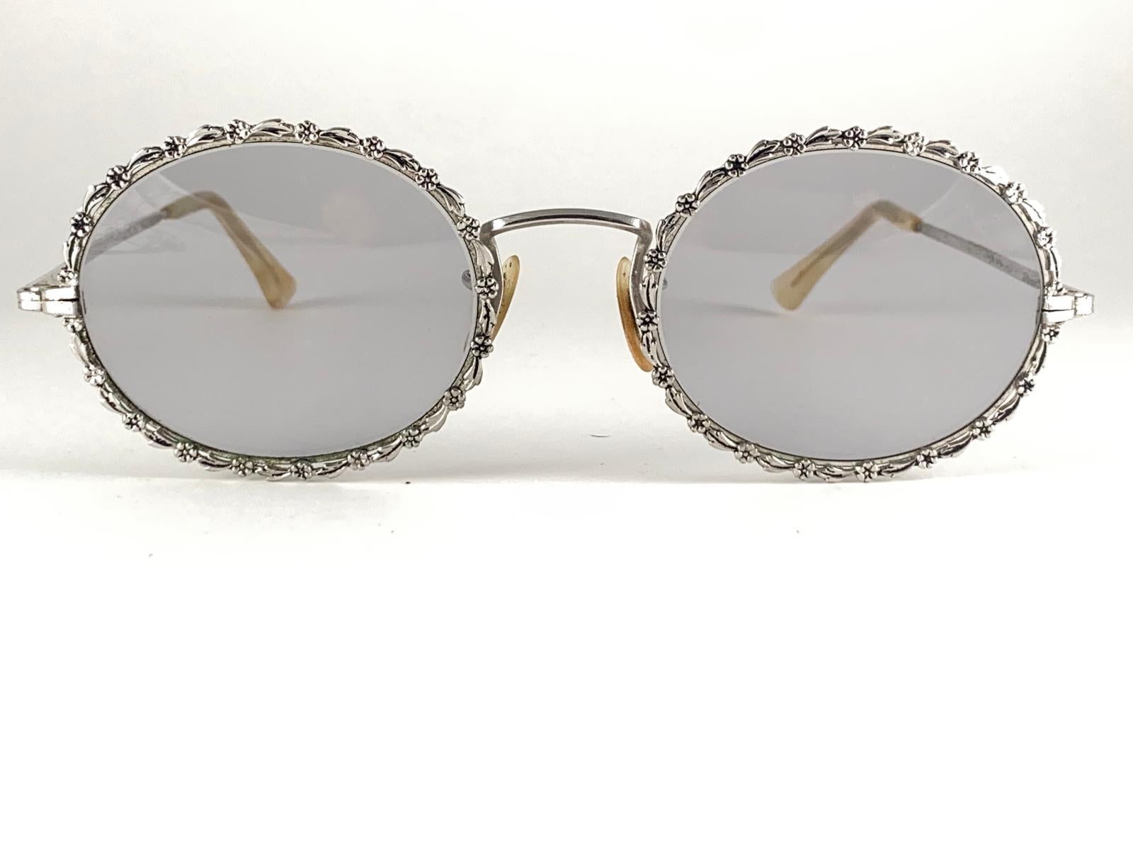 This is a seldom and rare piece not only for its aesthetic value but for its importance in the sunglasses and fashion history.   
Delicate ornamented cast iron frame emulating flowers and leaves.
Please noticed this item its nearly 75 years old and