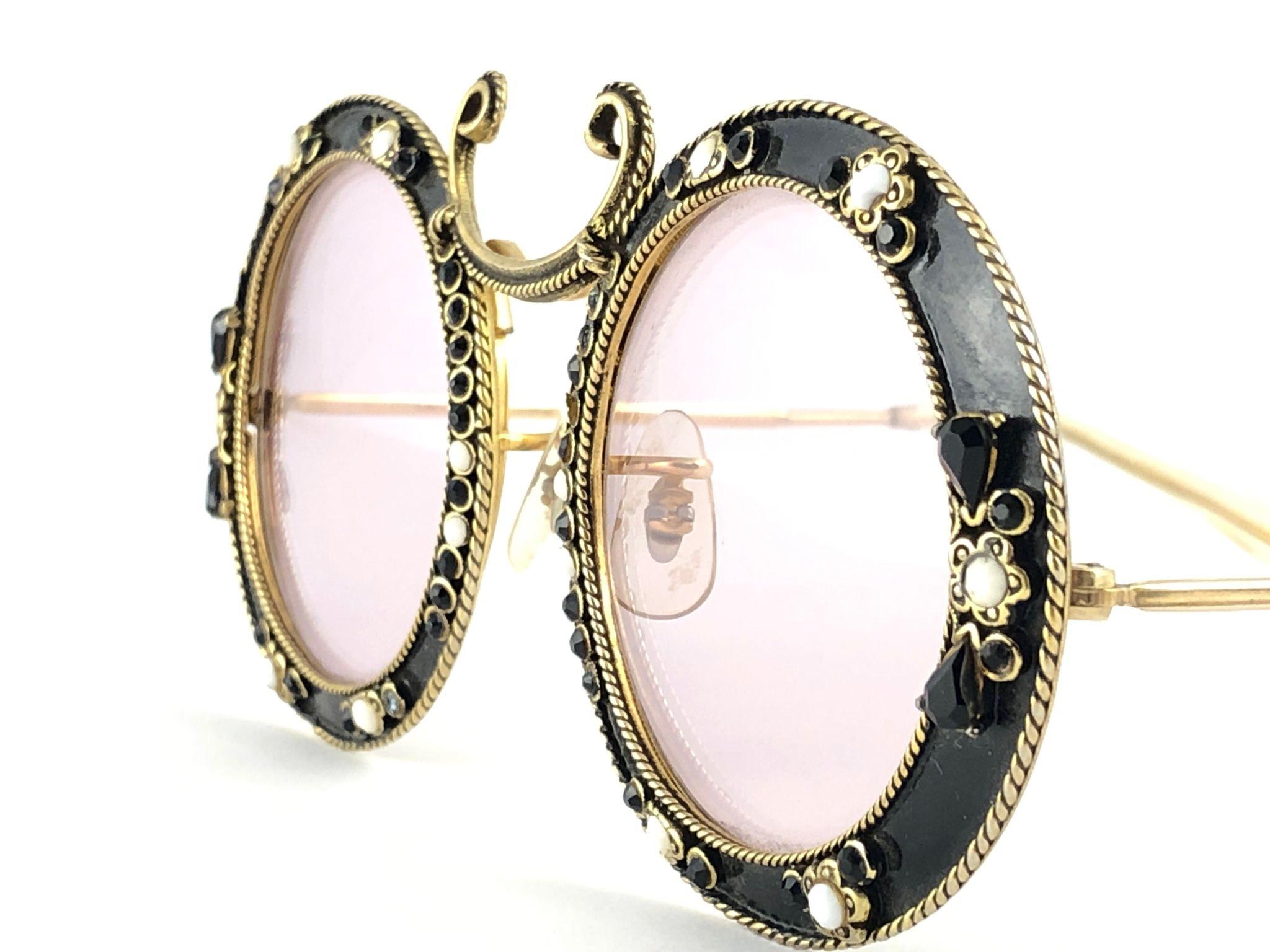 Ultra rare pair of Christian Dior Sunglasses circa 1960's by Tura.  

This is a seldom and rare piece not only for its aesthetic value but for its importance in the sunglasses and fashion history.   
Delicate enamel ornamented cast iron frame with