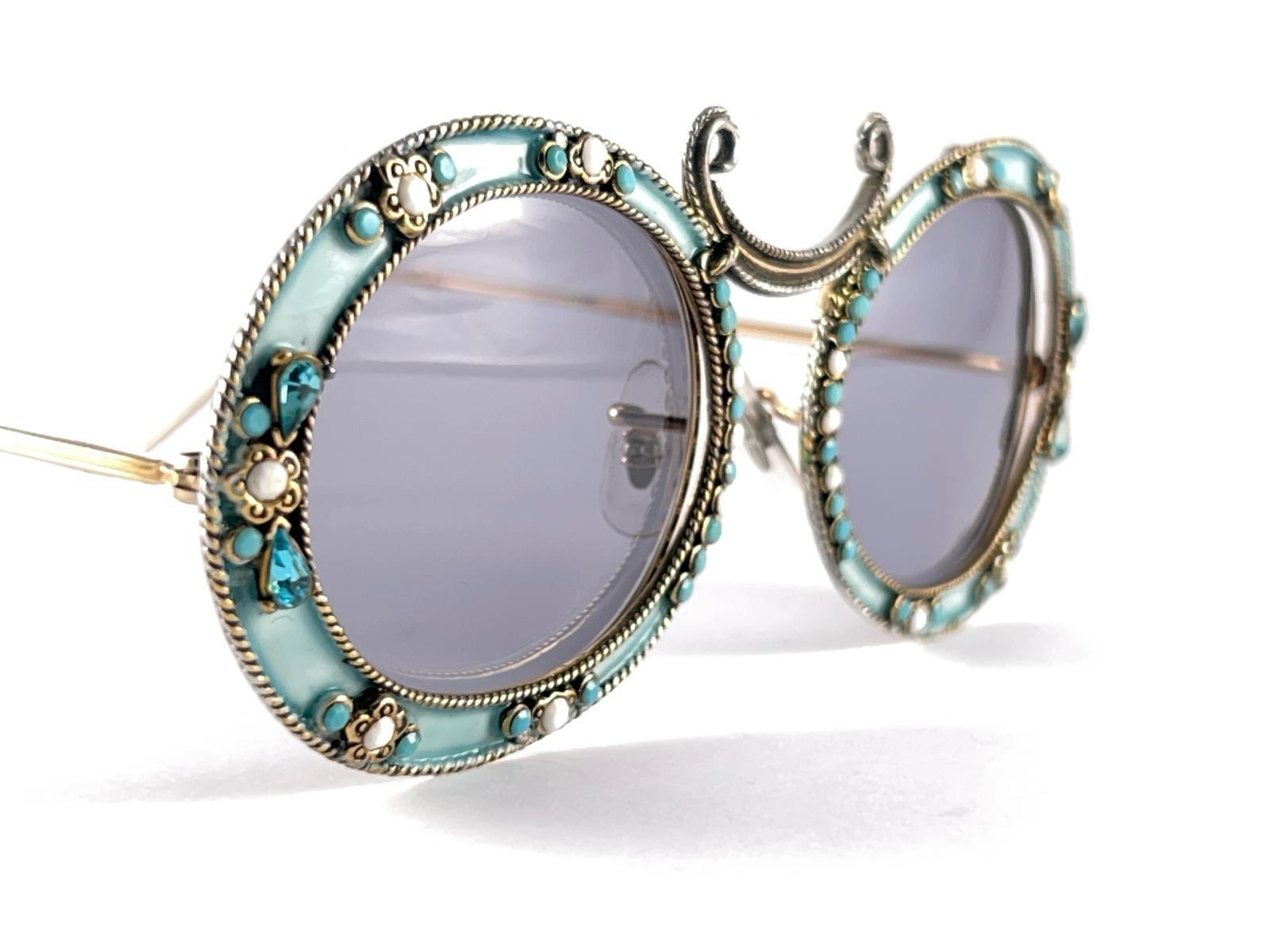 Ultra rare pair of Christian Dior Sunglasses circa 1960's by Tura.  

This is a seldom and rare piece not only for its aesthetic value but for its importance in the sunglasses and fashion history.   
Delicate enamel ornamented cast iron frame with