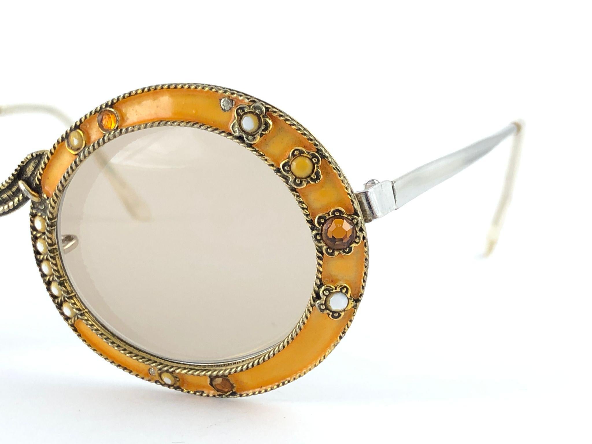 Ultra rare pair of Christian Dior Sunglasses circa 1960's by Tura.  

This is a seldom and rare piece not only for its aesthetic value but for its importance in the sunglasses and fashion history.   
Delicate enamel ornamented cast iron frame with
