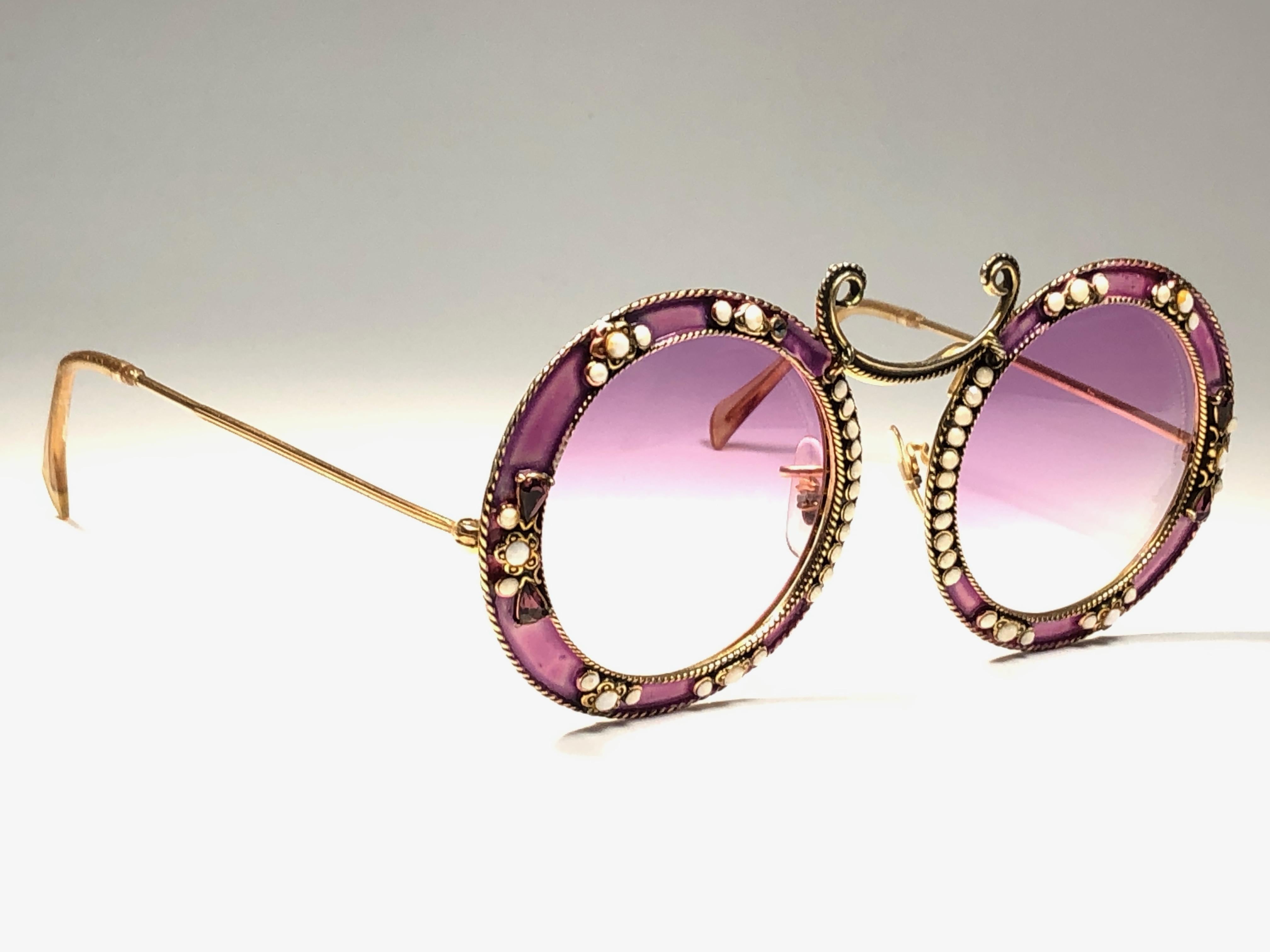 Ultra rare pair of Christian Dior Sunglasses circa 1960's by Tura.  

This is a seldom and rare piece not only for its aesthetic value but for its importance in the sunglasses and fashion history.   
Delicate enamel ornamented cast iron frame with