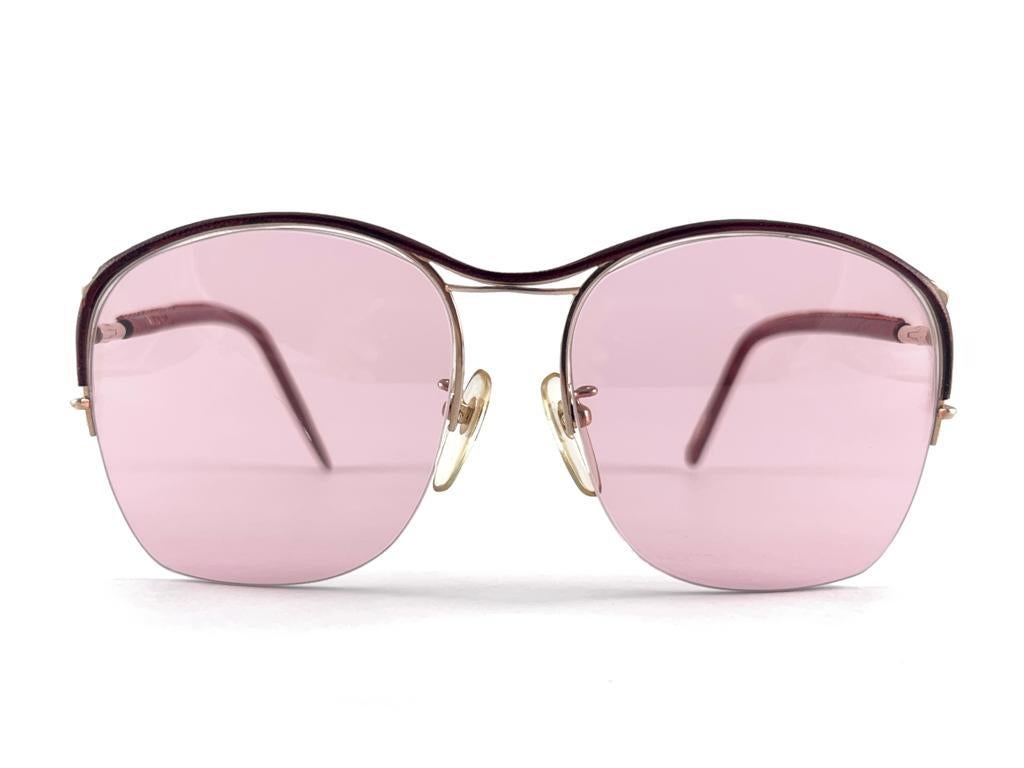 Ultra Rare 1970's Tura 450 Half Frame Burgundy Leather Pink Lenses Sunglasses
This is a seldom and rare piece not only for its aesthetic value but for its importance in the sunglasses and fashion history.   
Please notice this item its nearly 50
