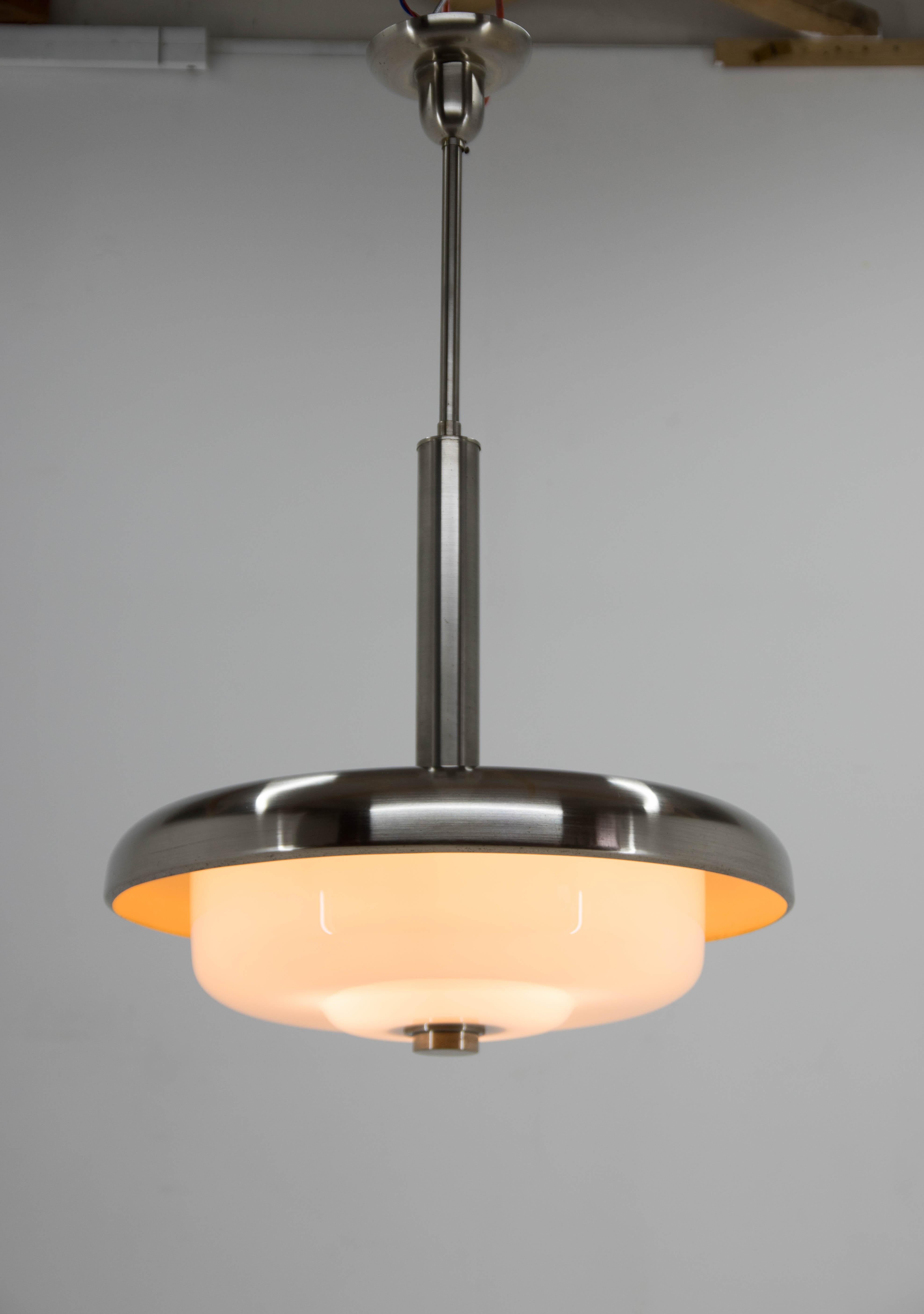 Stunning Bauhaus chandelier executed by IAS in 1930s.
Opaline glass shade marked by Pyroplex.
Very good original condition.
Nickel polished, rewired:
3x60W, E25-E27 bulbs
US wiring compatible
Shipping quote to US on request.