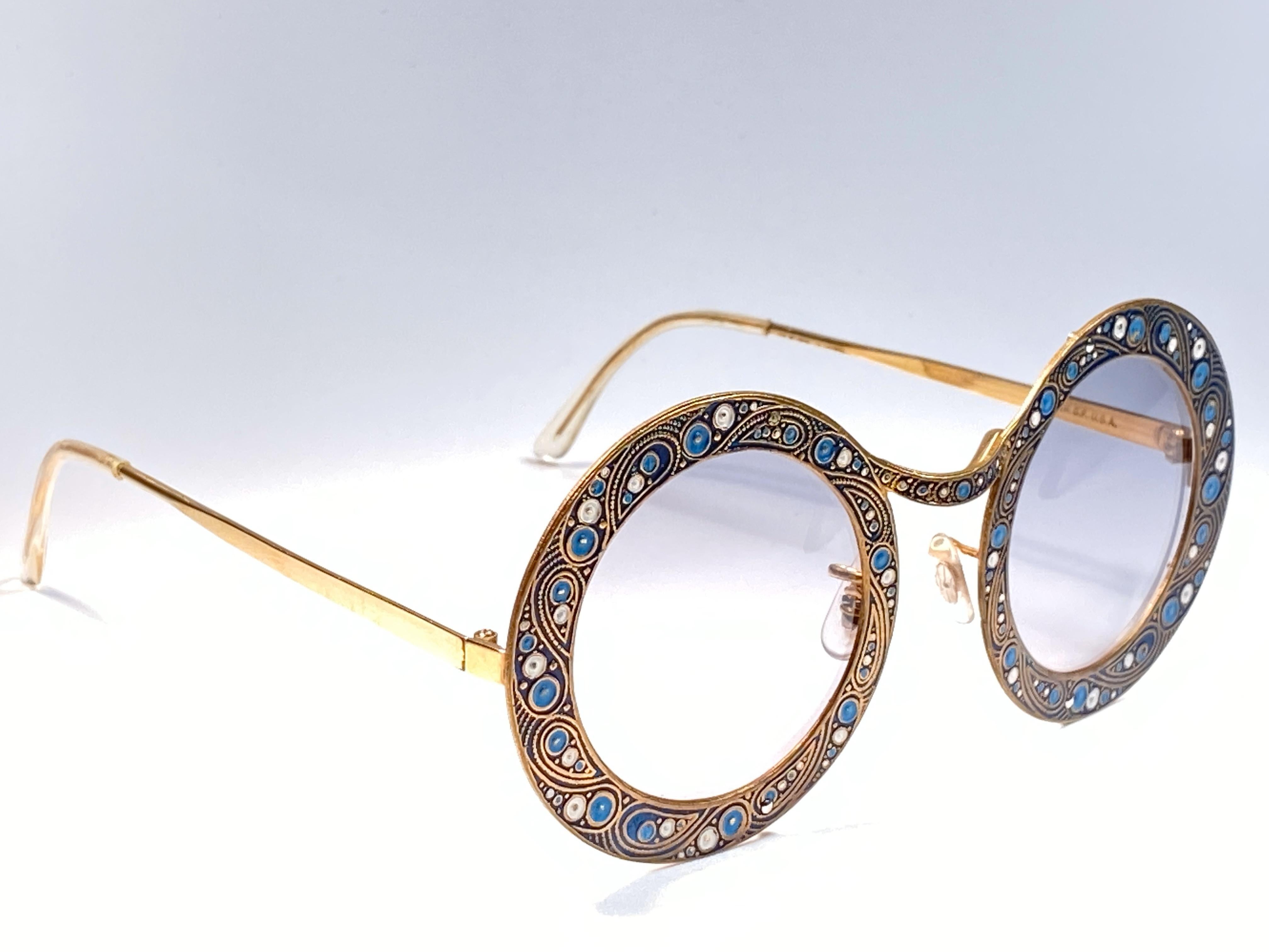 Ultra rare pair of Christian Dior Sunglasses circa 1969.

This is a seldom and rare piece not only for its aesthetic value but for its importance in the sunglasses and fashion history. 

Delicate enamel ornamented plated frame.

Please noticed this
