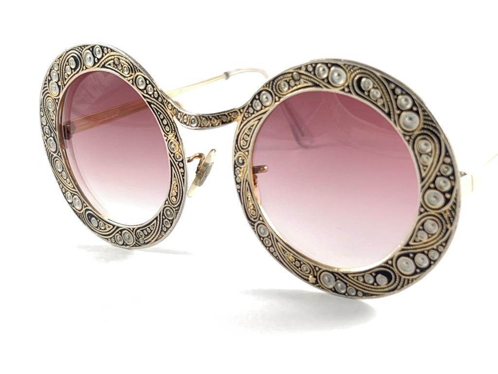 Ultra rare pair of Christian Dior Sunglasses circa 1969.

This is a seldom and rare piece not only for its aesthetic value but for its importance in the sunglasses and fashion history. 

Delicate enamel ornamented plated frame.

Please noticed this