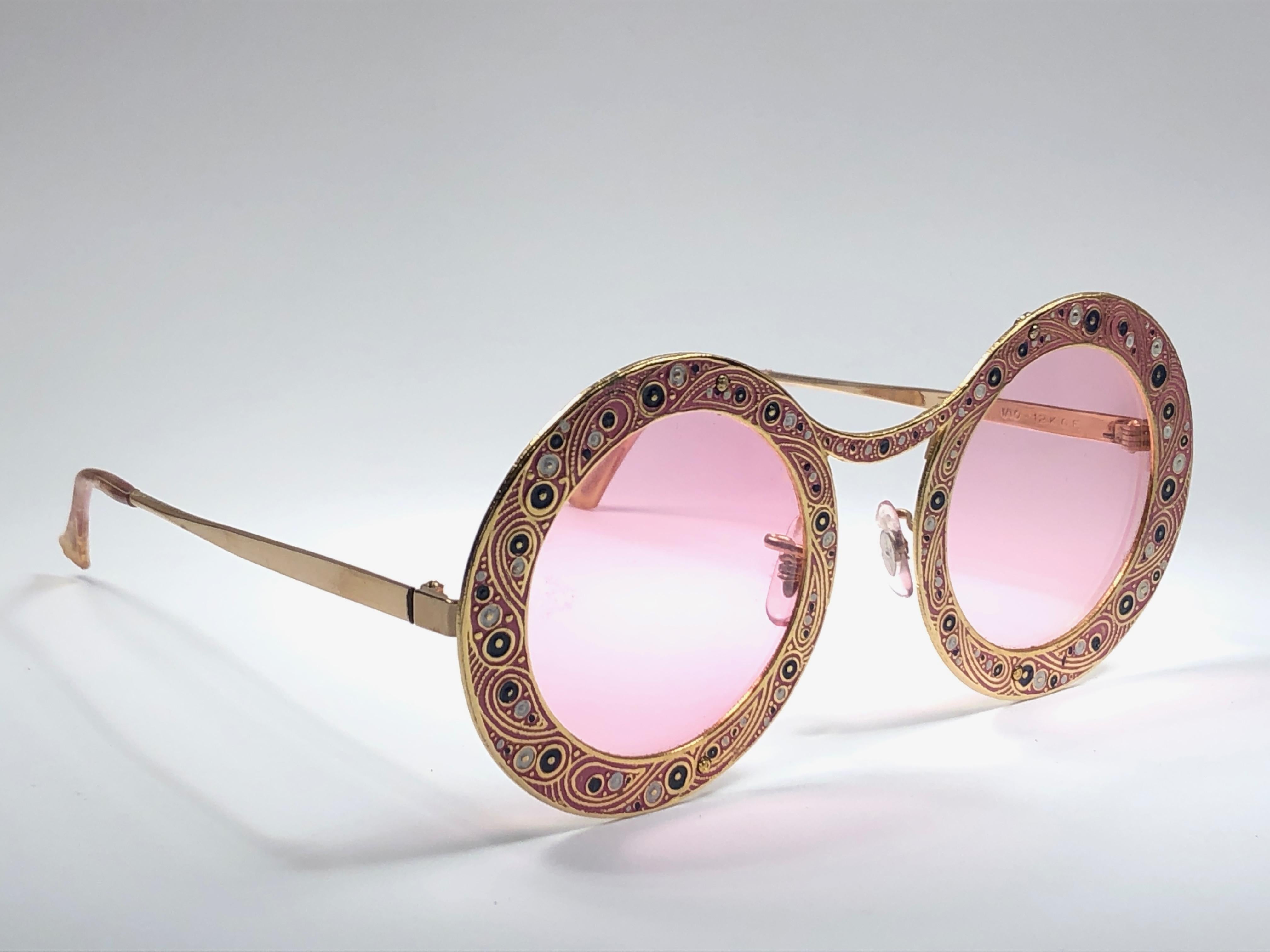 Ultra rare pair of Christian Dior Sunglasses circa 1969.

This is a seldom and rare piece not only for its aesthetic value but for its importance in the sunglasses and fashion history. 

Delicate enamel ornamented plated frame.

Please noticed this
