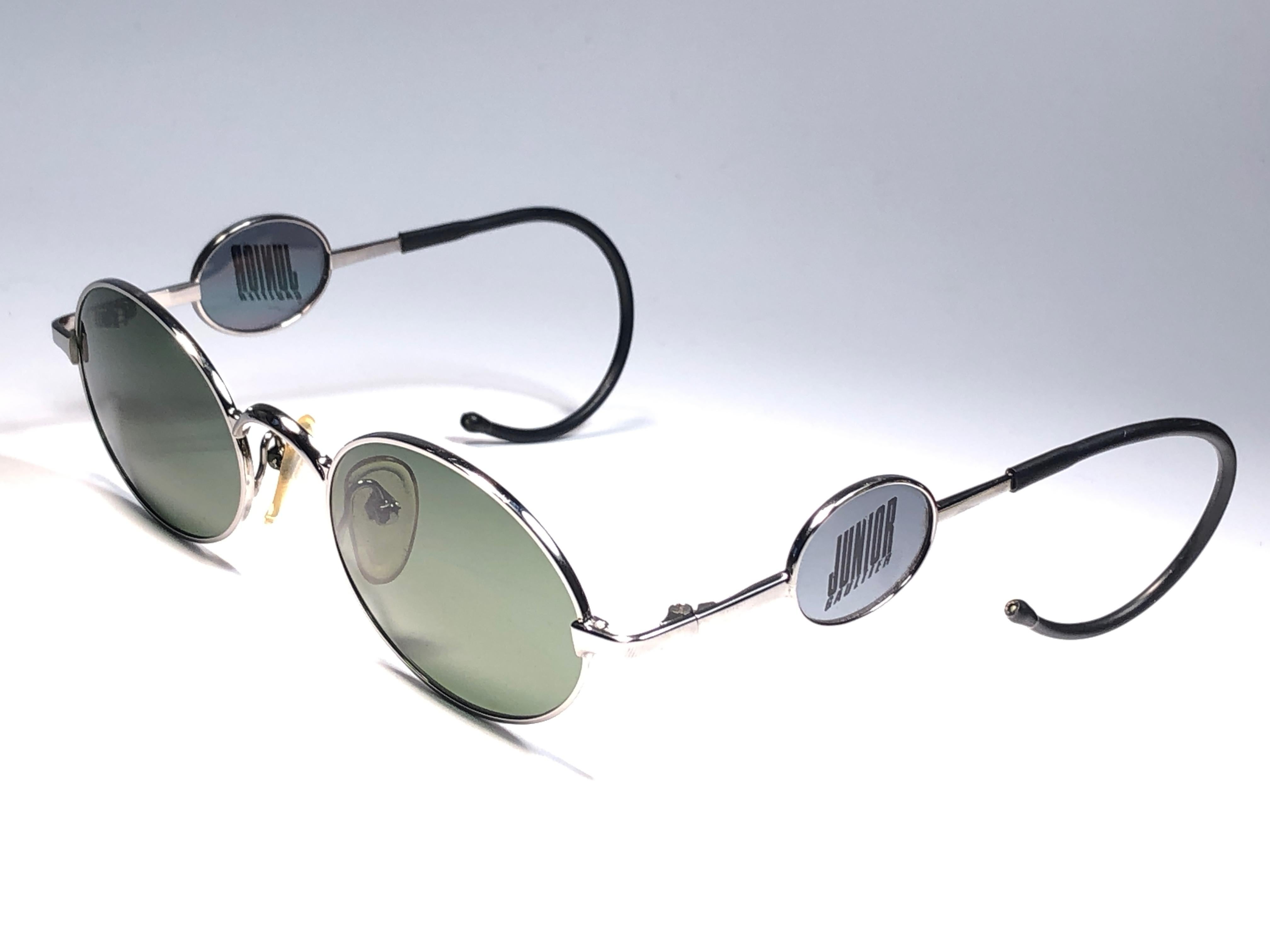 Vintage Rare & Seldom Jean Paul Gaultier Junior sleek silver frame double lenses frame.
Dark green lenses that complete a ready to wear JPG look. 

Amazing design with strong yet intricate details.
Design and produced in the 1900's.
Light wear from