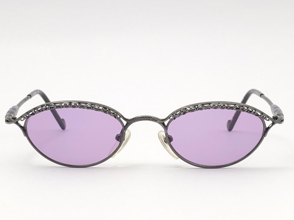 Vintage Rare & Seldom Jean Paul Gaultier sleek dark silver frame.

Purple lenses that complete a ready to wear JPG look. 

Amazing design with strong yet intricate details.
Design and produced in the 1900's.
Light wear from storage.
A true fashion