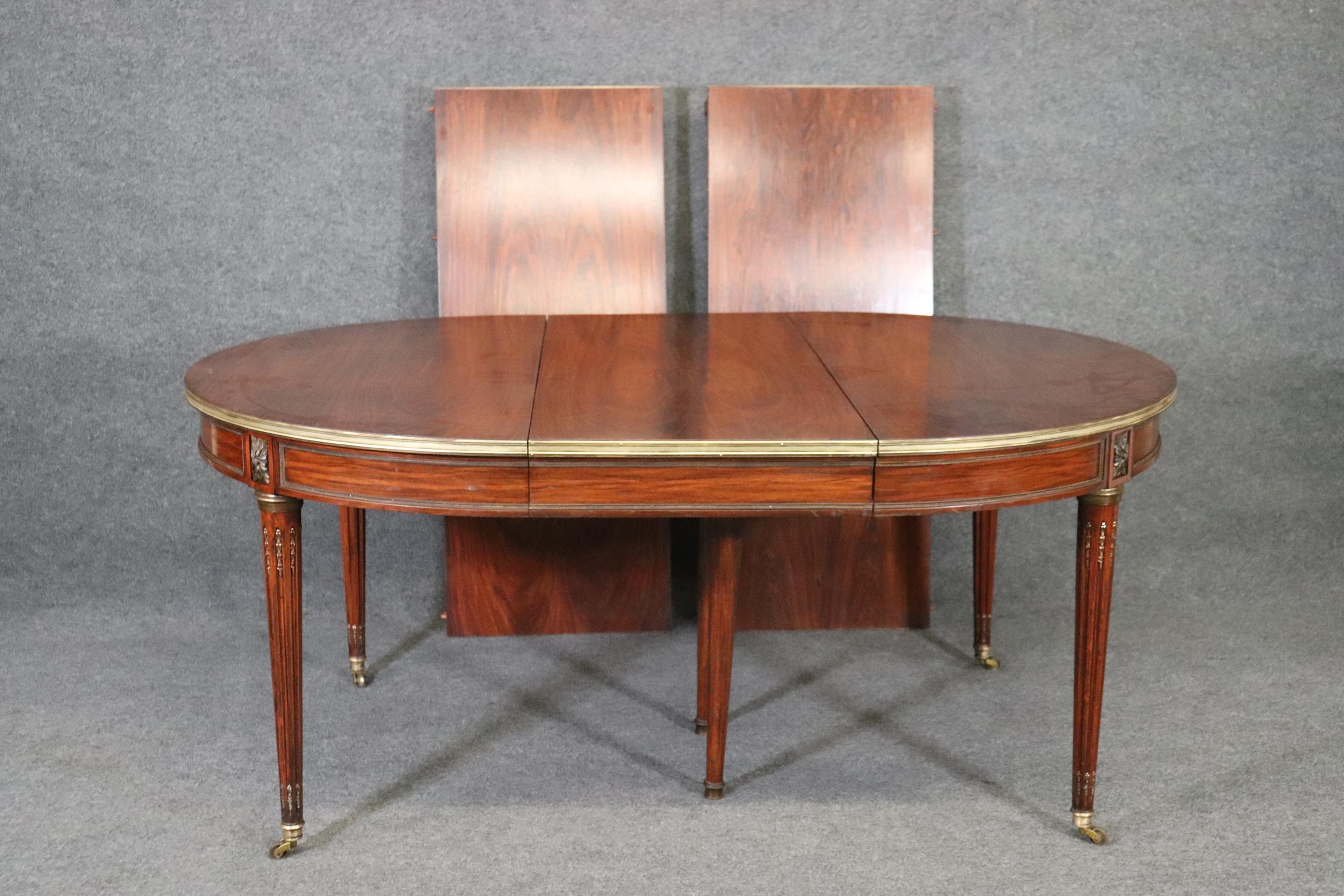 This is one of the rarest of all Maison Jansen dining tables. This form of circular dining table is not rare- but in ROSEWOOD it certainly is! This may be one of a handful of rosewood Jansen tables ever made. This is a unicorn in the world of