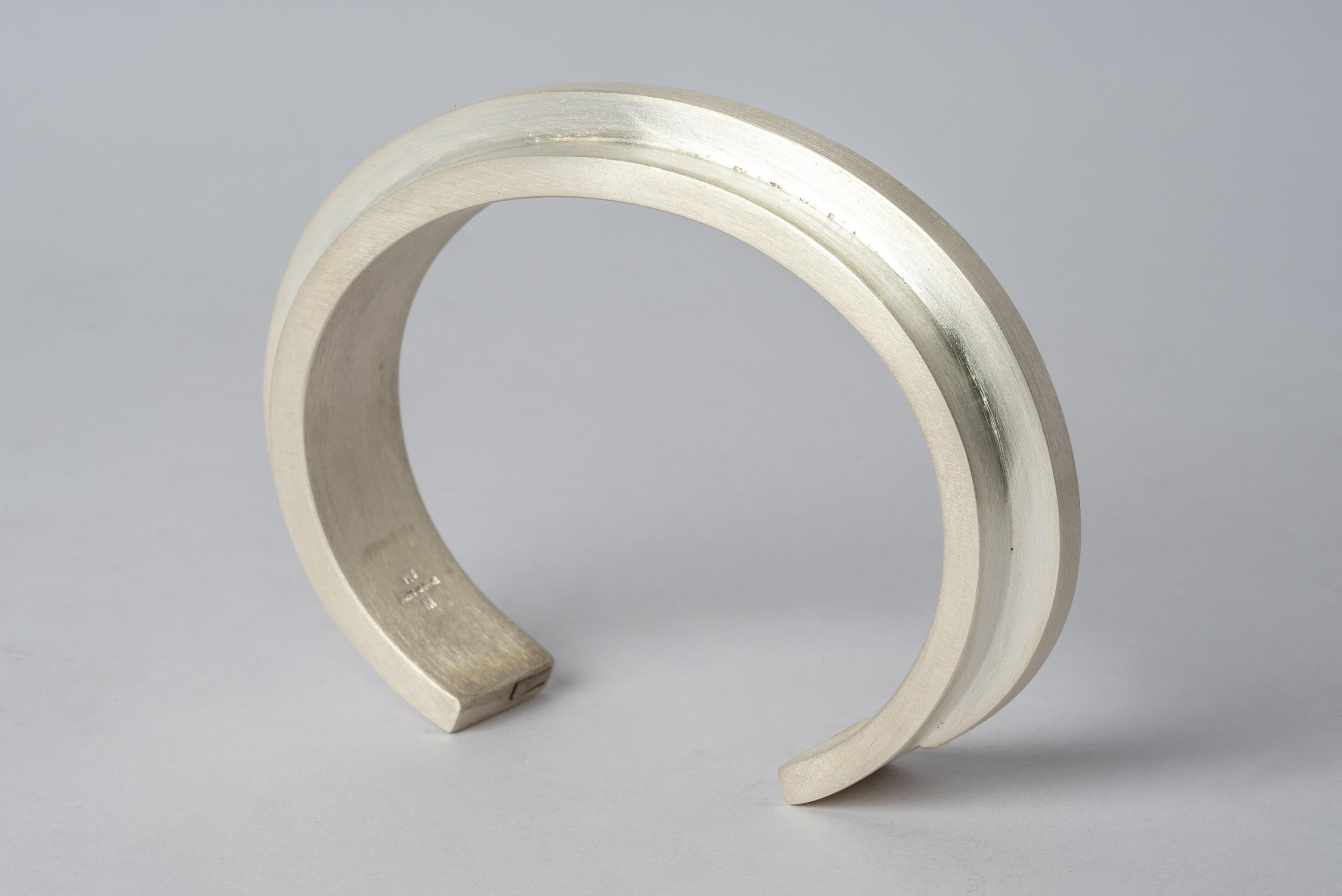 Bracelet in matte sterling silver. This piece is 100% hand fabricated from metal plate; cut into sections and soldered together to make the hollow three dimensional form. If sterling silver, the sheet metal is made by hand. The silver is melted and