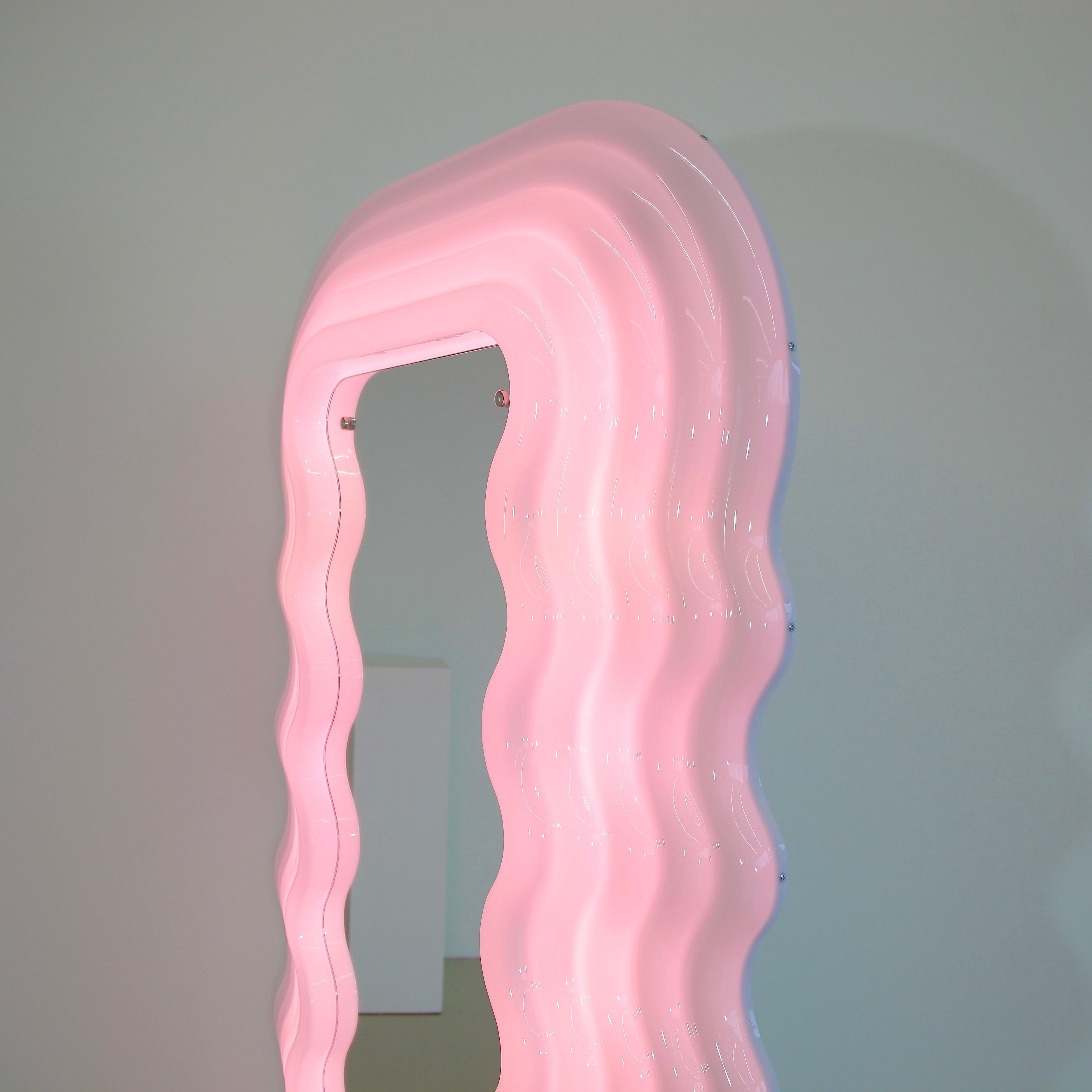 Ultrafragola mirror, designed by Ettore Sottsass, Italy, 1970.

Recent production mirror made of moulded fibreglass with hard-back and shaped mirror. The frame is white, turning pink when the light is switched on. Original label on bottom of