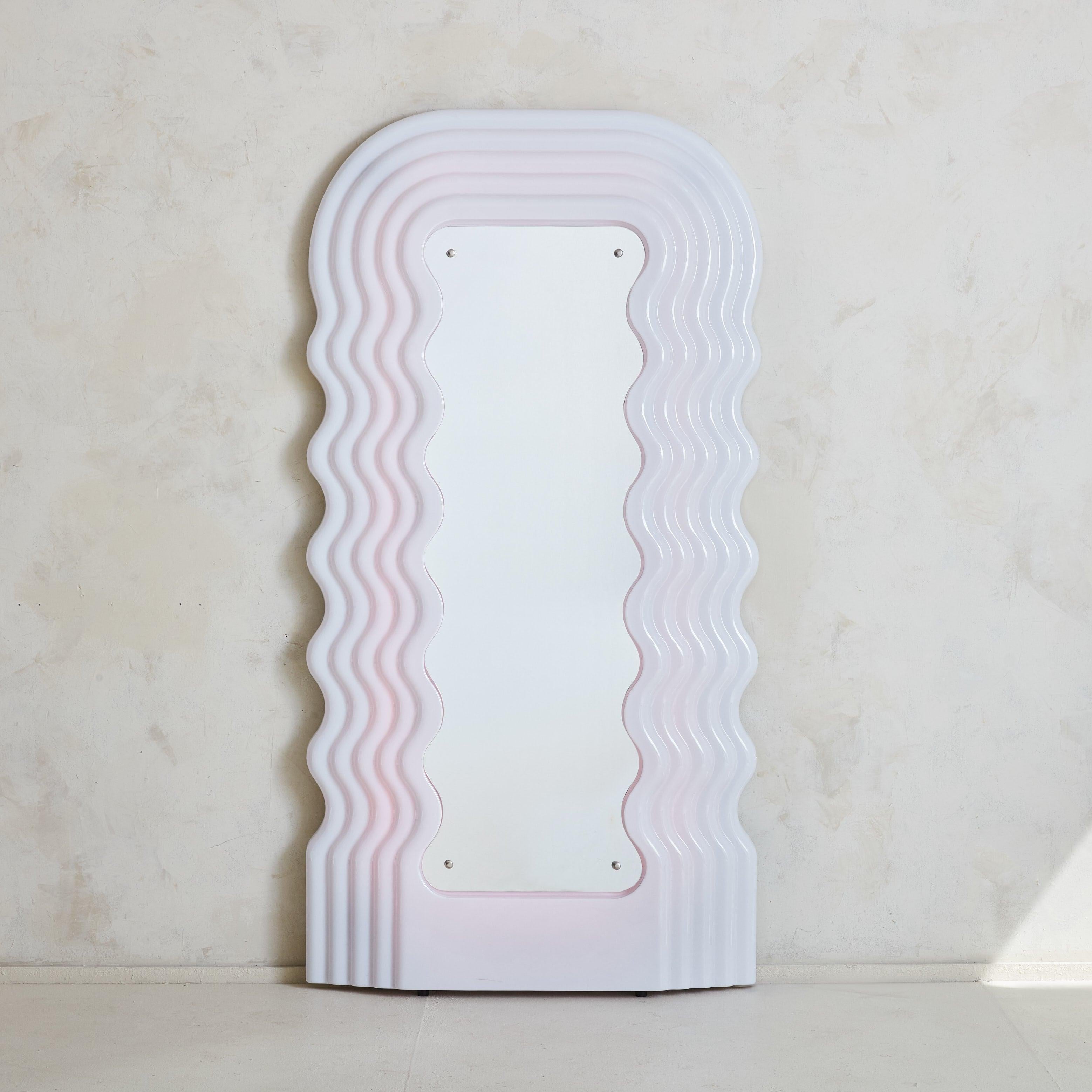 The Ultrafragola Mirror, designed by Italian architect Ettore Sottsass in 1970, stands as a quintessential piece of postmodern design. As part of the Mobili Grigi series of bedroom and living room objects, the Ultrafragola Mirror was the only piece