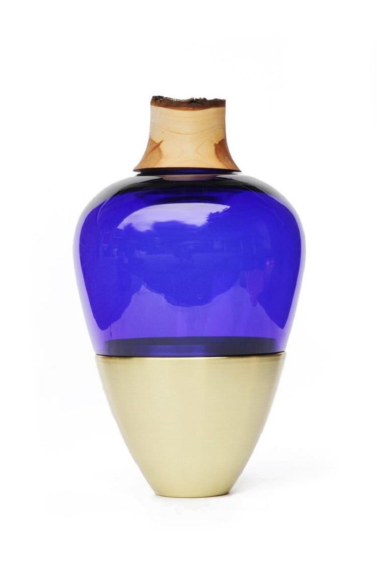 Ultramarine India Vessel I, Pia Wüstenberg.
Dimensions: D 20 x H 38.
Materials: glass, wood, metal.
Available in other metals: brass, copper.

Handmade in Europe, by individual craftsmen: handblown glass (Czech Republic), hand spun metal,
