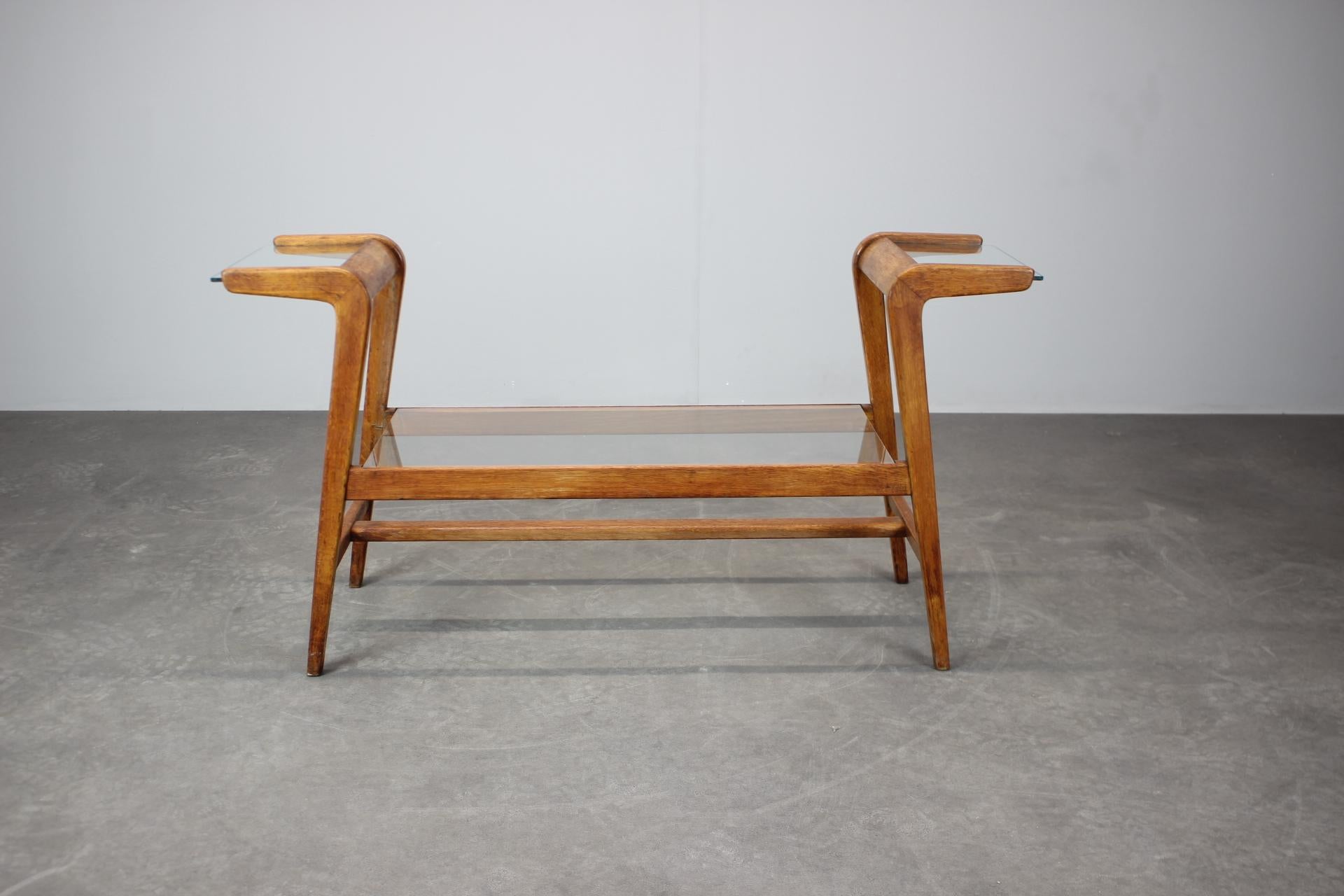 A sculptural mid-century plant stand attributed to ULUV, produced in Czechoslovakia during the 1960s. The stand features a distinctive wooden frame with clean architectural lines and a central glass display shelf. The middle glass shelf has been