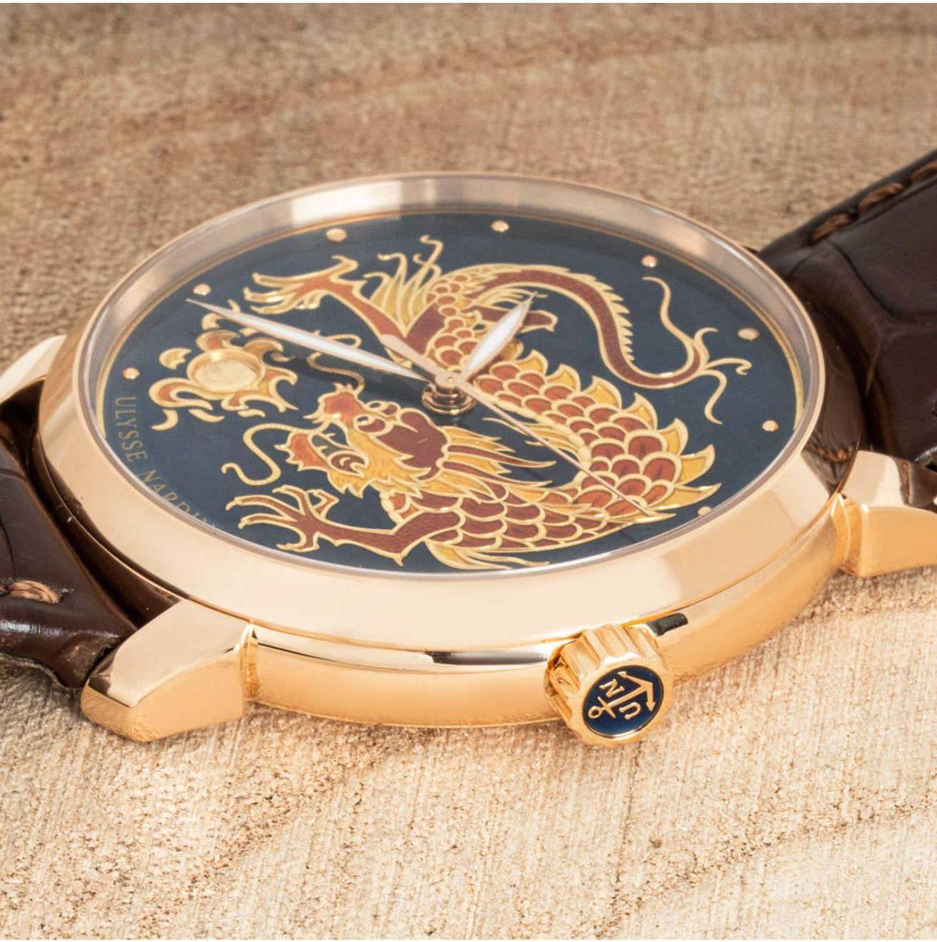 A rose gold limited edition Classico Dragon Wristwatch by Ulysse Nardin. Featuring a stunning blue enamel dial depicting a fire-breathing dragon and a rose gold bezel. Fitted with a sapphire glass and a self-winding automatic movement which can be